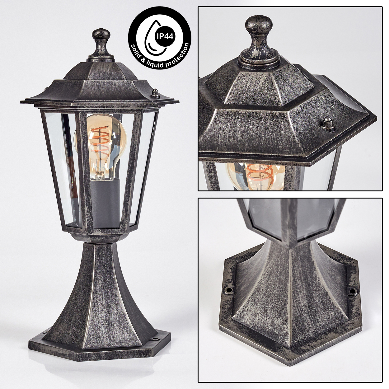 Eine metallische Außenlampe mit Glasscheiben und einer warmen Glühbirne. Sie hat eine dekorative Spitze und einen stabilen Sockel.