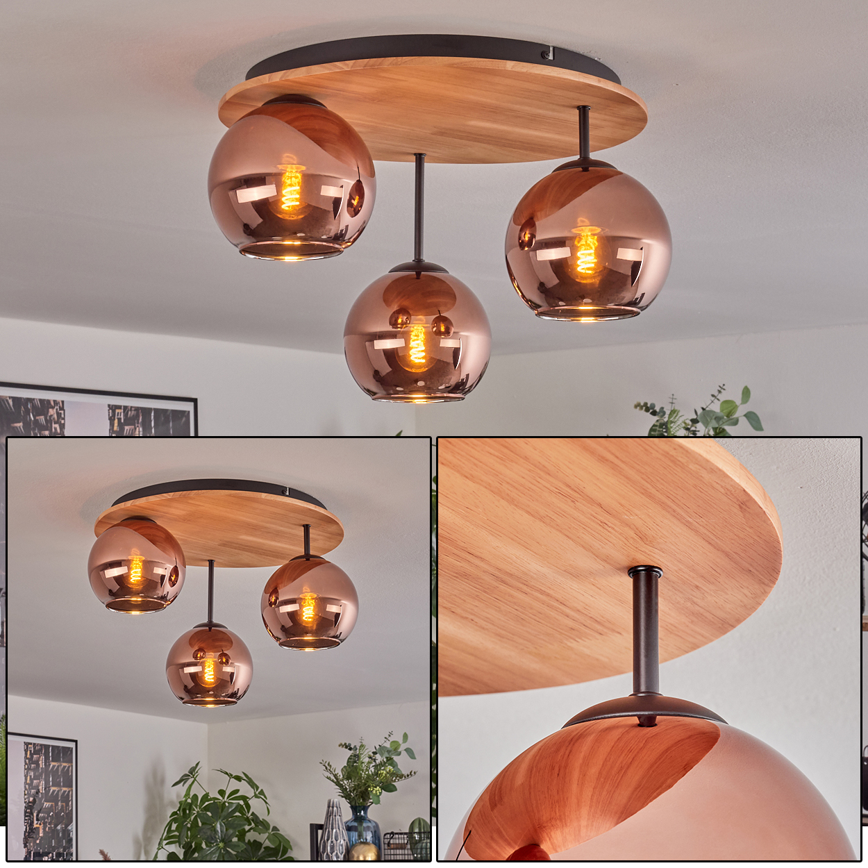 Deckenleuchte mit drei kupferfarbenen Kugelleuchten. Holzsockel und schwarze Metallstützen. Hintergrund: Pflanzen und Kunst.