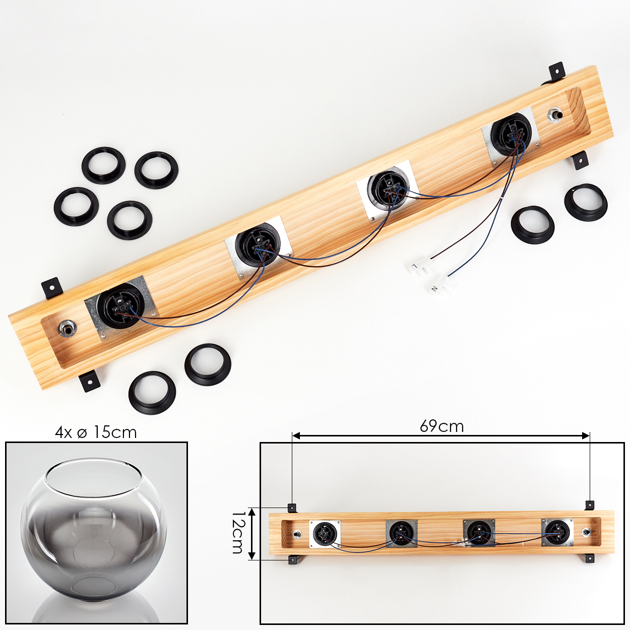 Holzbrett mit vier Lautsprechern, Kabeln und schwarzen Ringen. Auf der unteren linken Seite befindet sich eine kleine Glasschale. Maße sind angegeben.