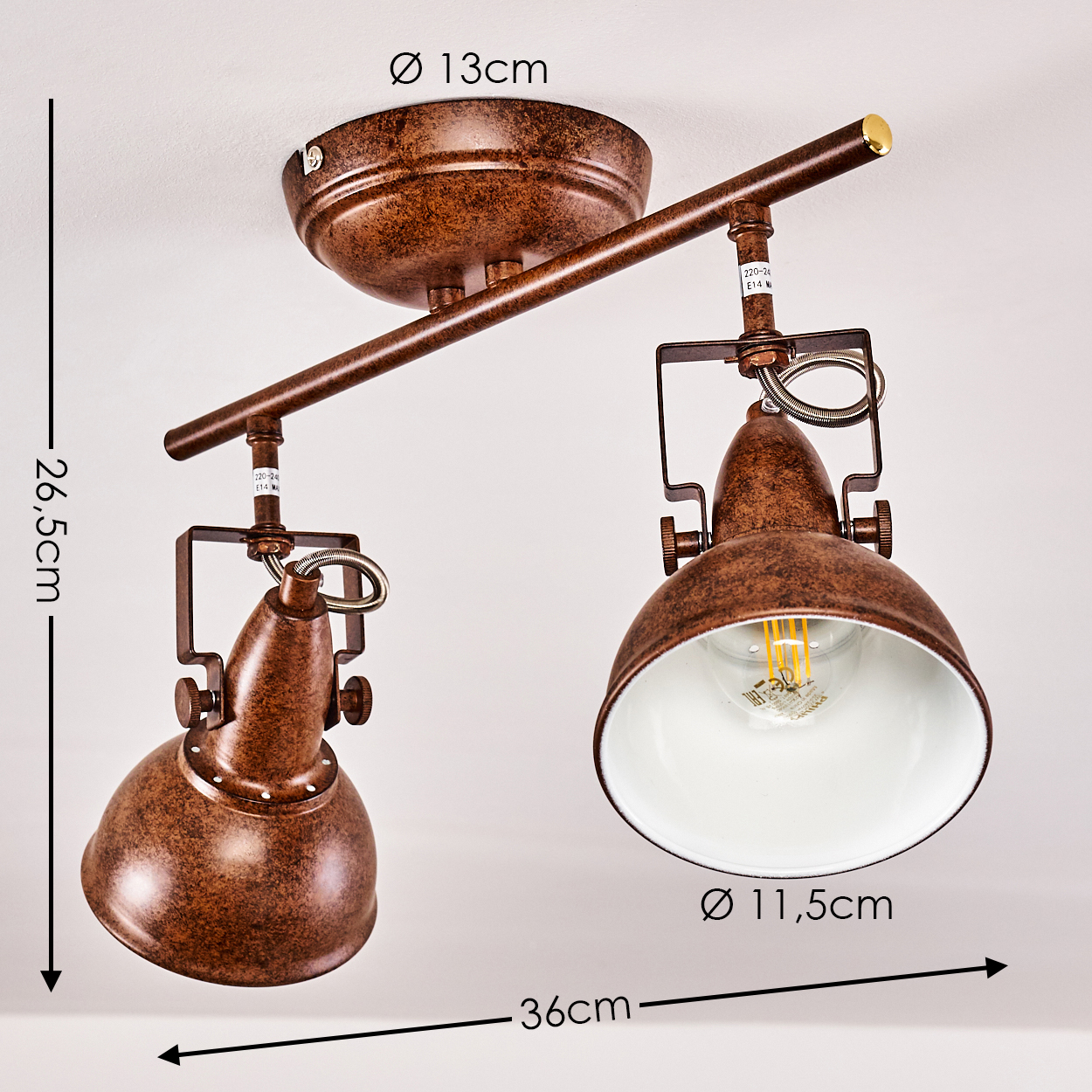 Ein brauner Deckenstrahler mit zwei Lampen. Jede Lampe hat eine weiße Innenseite und eine sichtbare Glühbirne. Maße sind ebenfalls vorhanden.