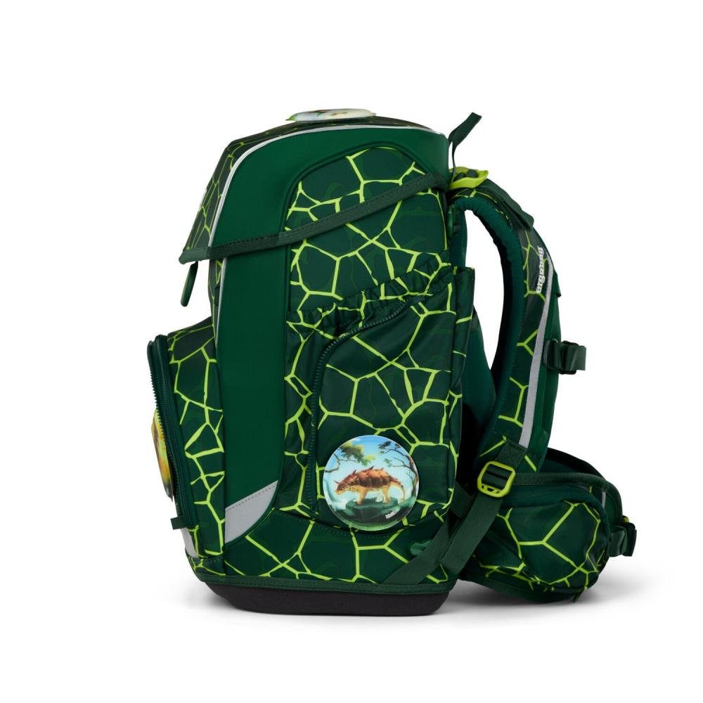Grüner Rucksack mit gelbem geometrischen Muster. Mit Dinosaurier-Abzeichen und reflektierenden Streifen. Seitentasche und verstellbare Träger.