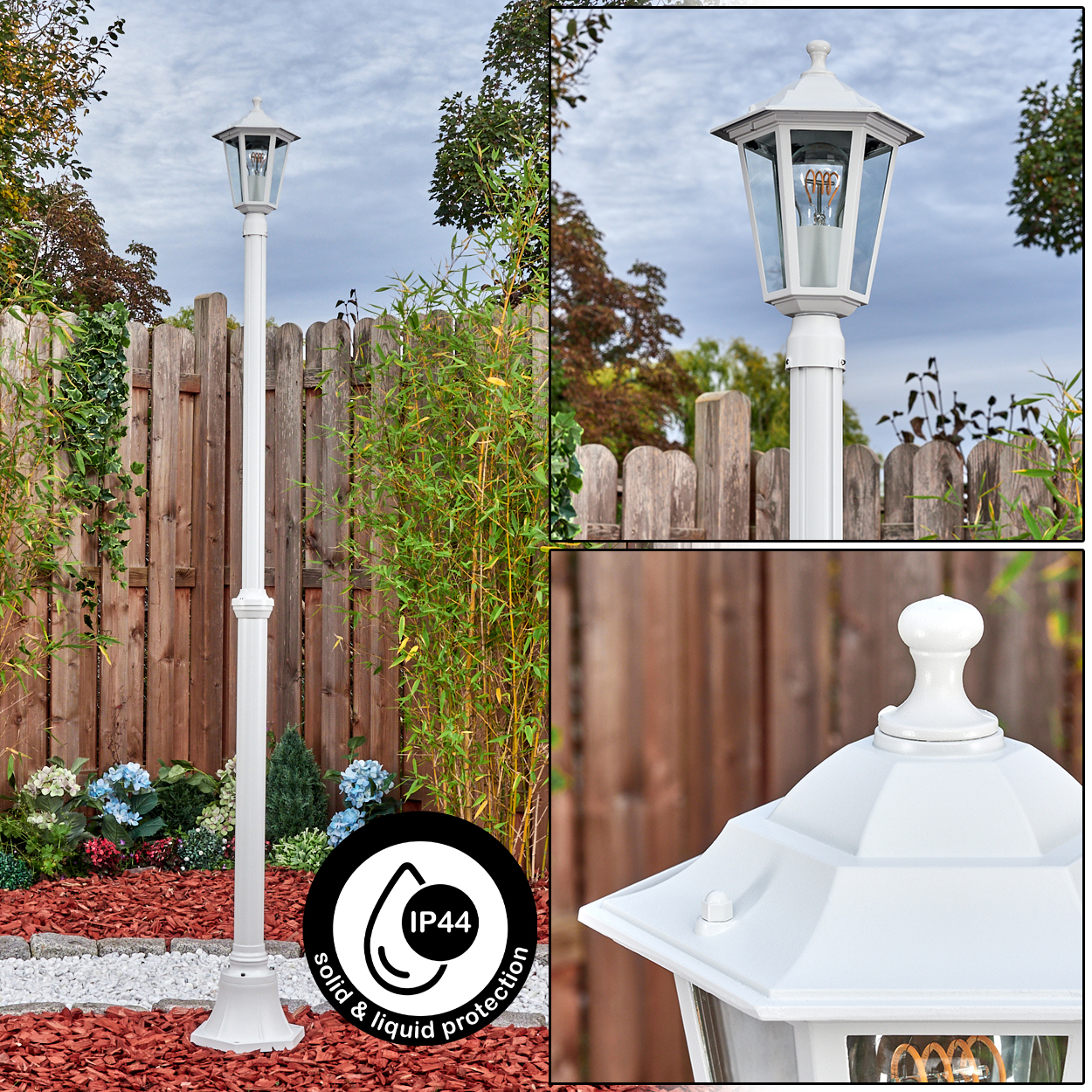Eine weiße Außenlaterne mit IP44-Aufkleber. Sie hat ein Glasgehäuse und befindet sich in einem Garten mit Holzzaun.