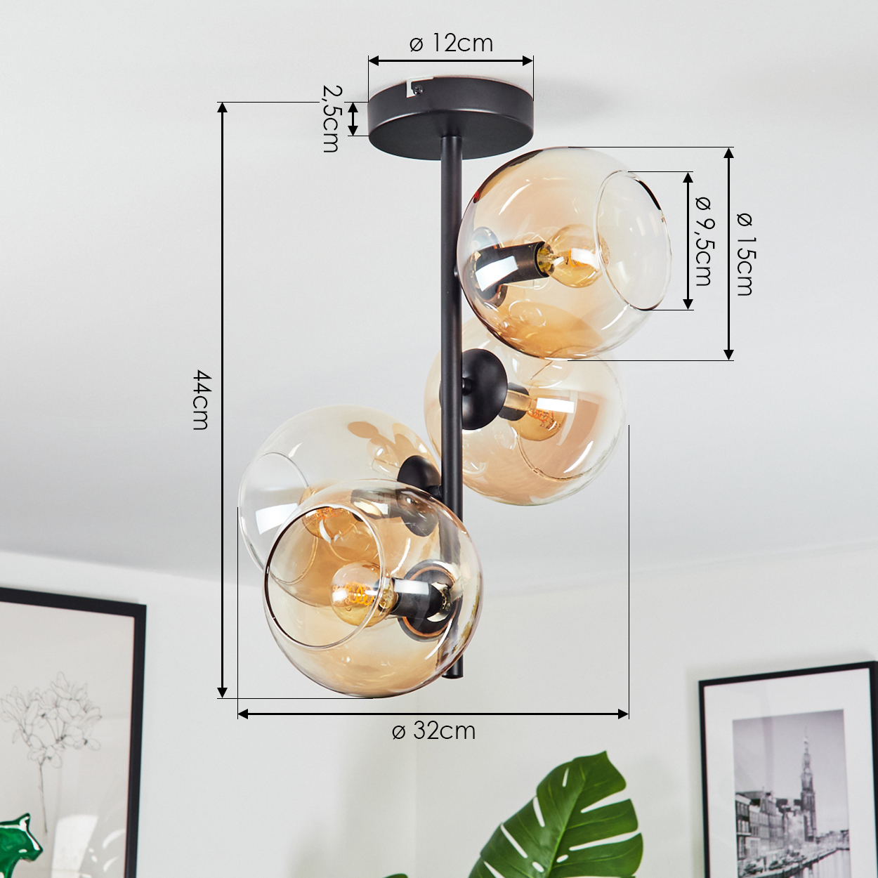 Eine moderne Deckenlampe mit drei bernsteinfarbenen Glaskugeln, schwarzen Armaturen und Maßangaben.