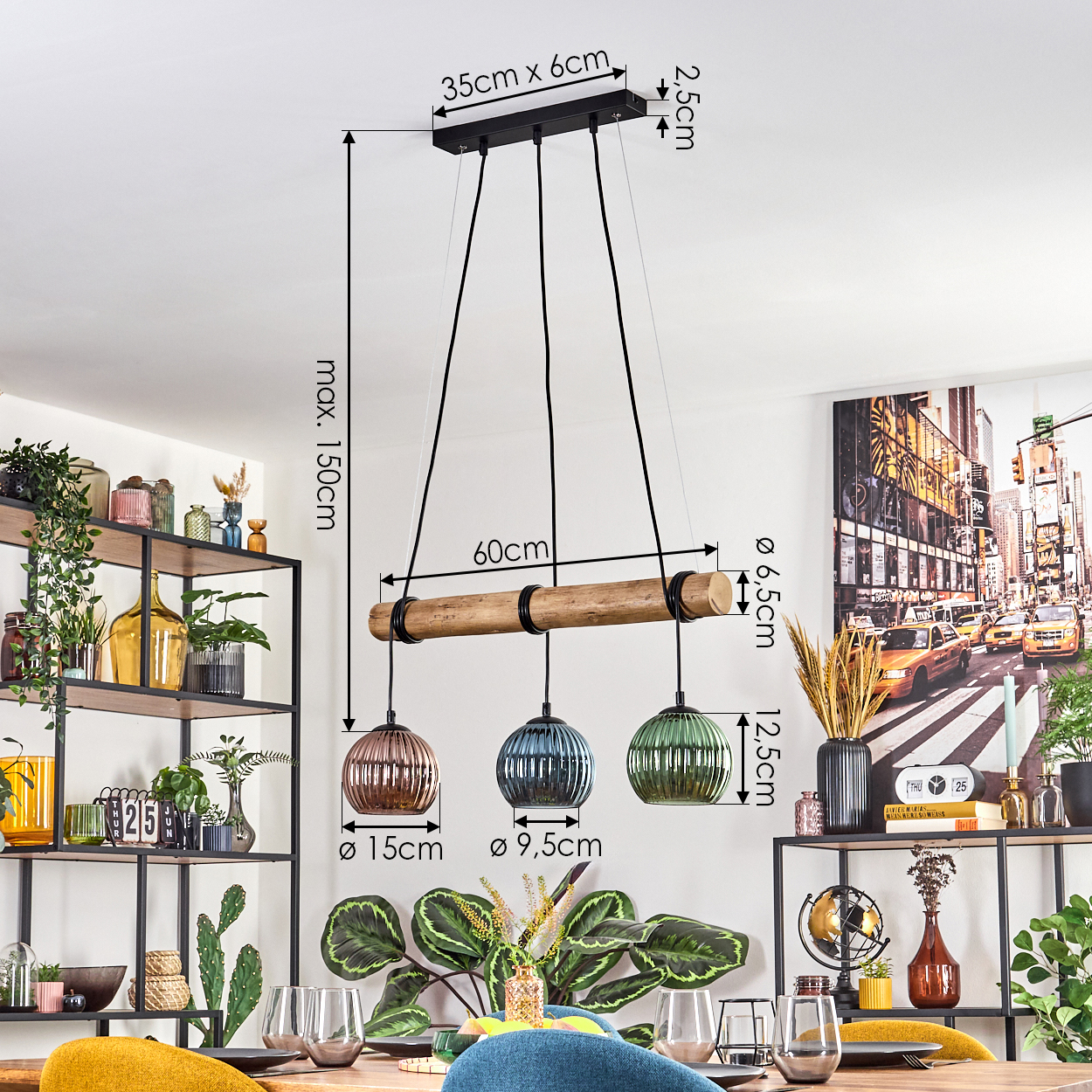 Esszimmer mit Holztisch und Pendelleuchte. Die Leuchte hat drei farbige Glaskugeln. Ein Stadtbildgemälde hängt an der Wand.