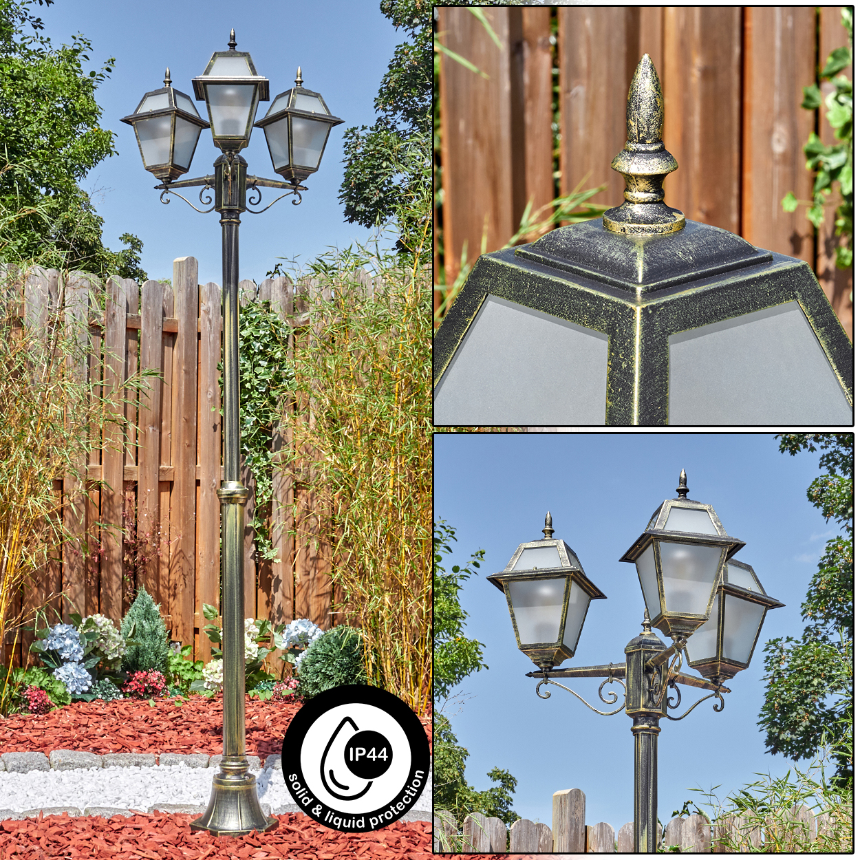 Eine Laterne mit drei Lampen im Freien. Sie ist gold und schwarz. Im Hintergrund befinden sich ein Holzzaun und Grün.