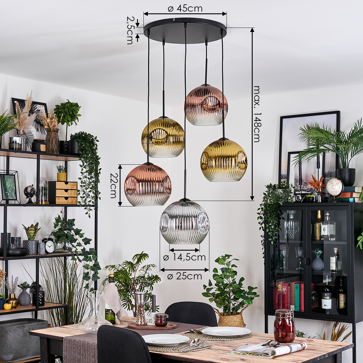 Esszimmer mit Holztisch, schwarzen Stühlen und Kronleuchter mit Glaskugeln in verschiedenen Farben.