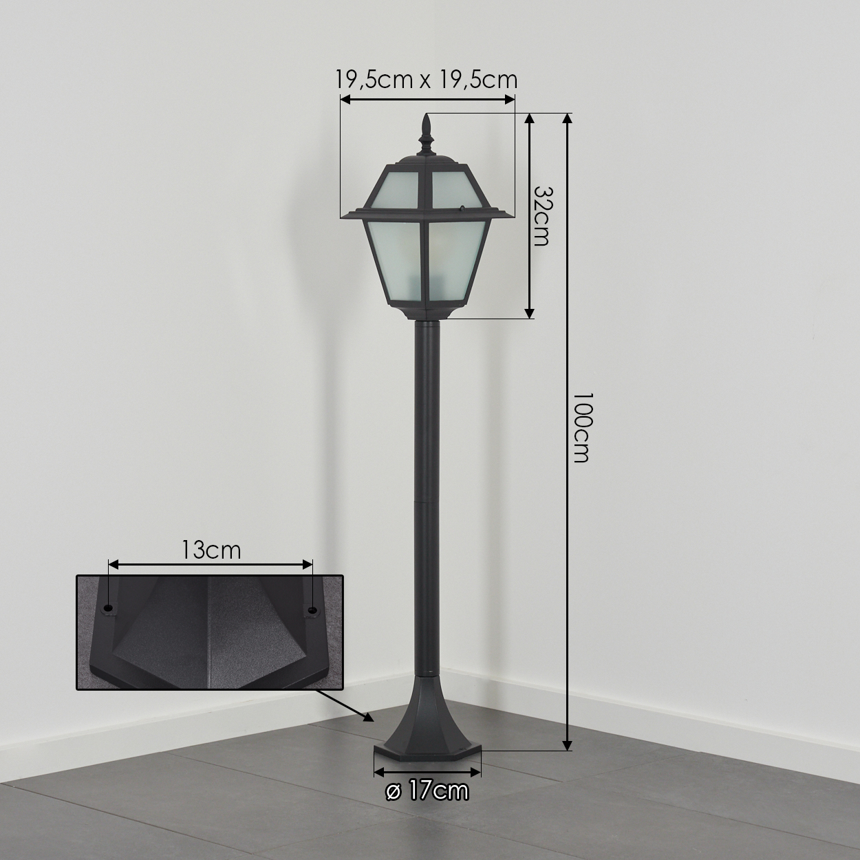 Schwarze Außenlampe. Abmessungen: 19,5 x 19,5 cm, 32 cm, 100 cm, 13 cm und 17 cm Durchmesser. Steht auf grauem Fliesenboden.