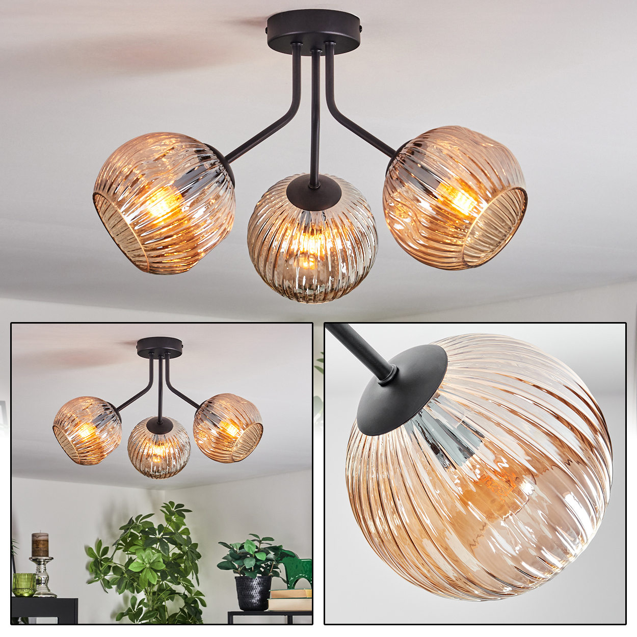 Eine moderne Deckenlampe mit drei bernsteinfarbenen Glaskugelschirmen. Schwarze Arme und Basis. Das Licht ist an. Der Hintergrund ist weiß.