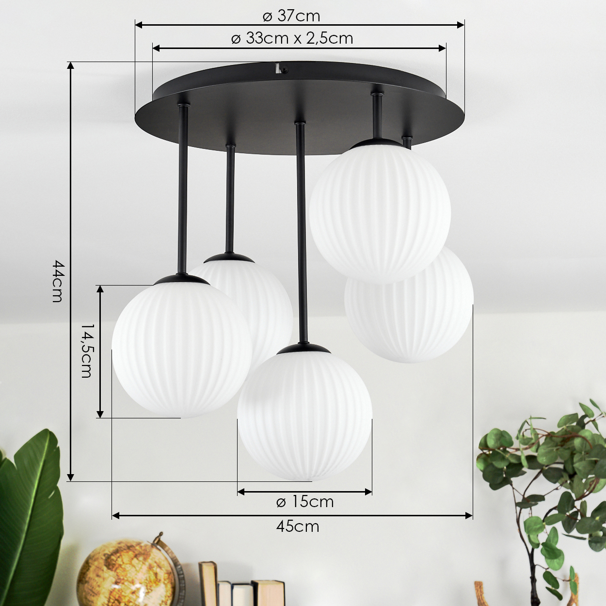 Eine moderne Deckenlampe mit fünf weißen, gerippten Glas-Kugelschirm, die von einer schwarzen runden Basis abgehängt sind. Abmessungen angegeben.