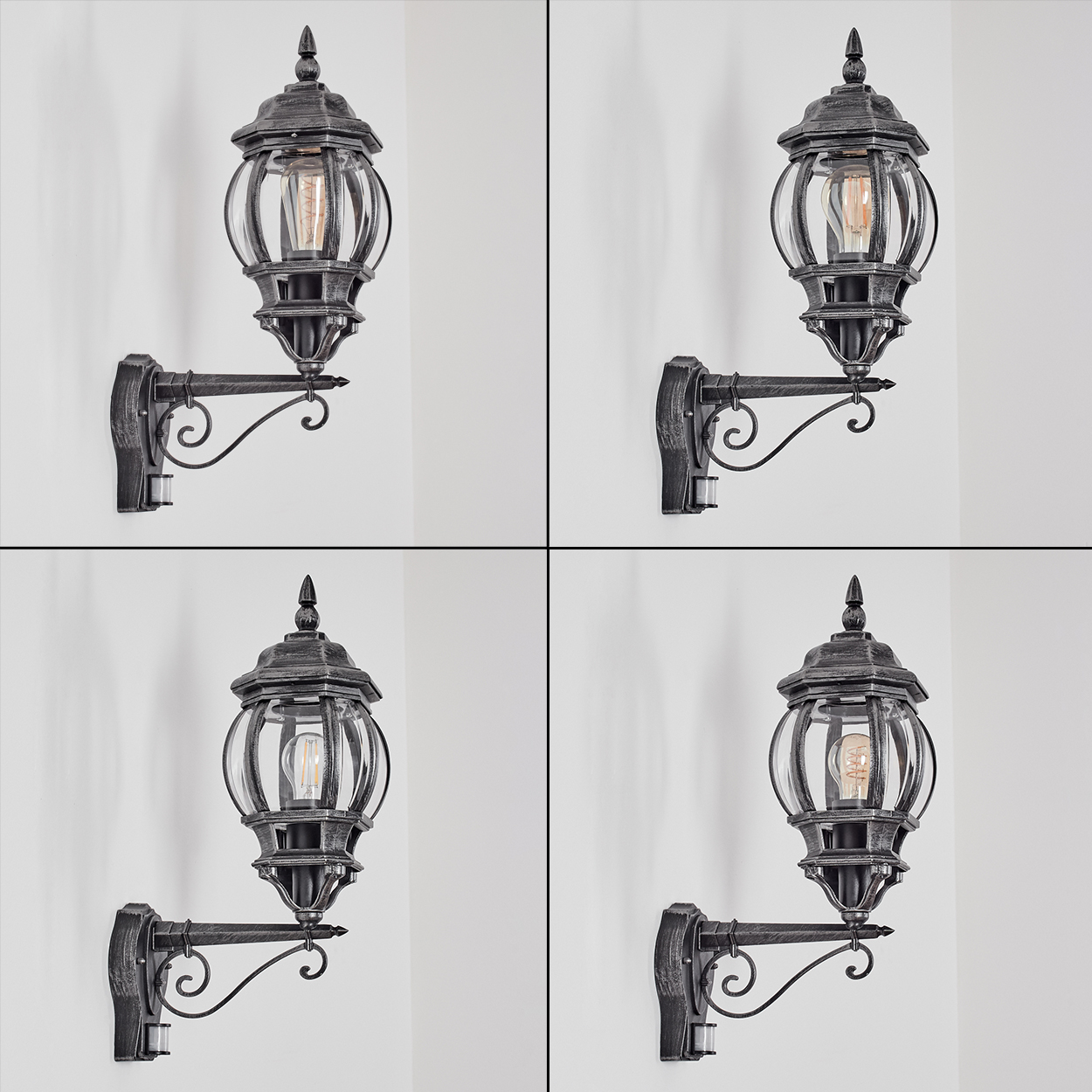 Vier Außenlampen an einer wei ßen Wand. Jede Lampe ist schwarz mit einem durchsichtigen Glaskolben und einem dekorativen Arm.