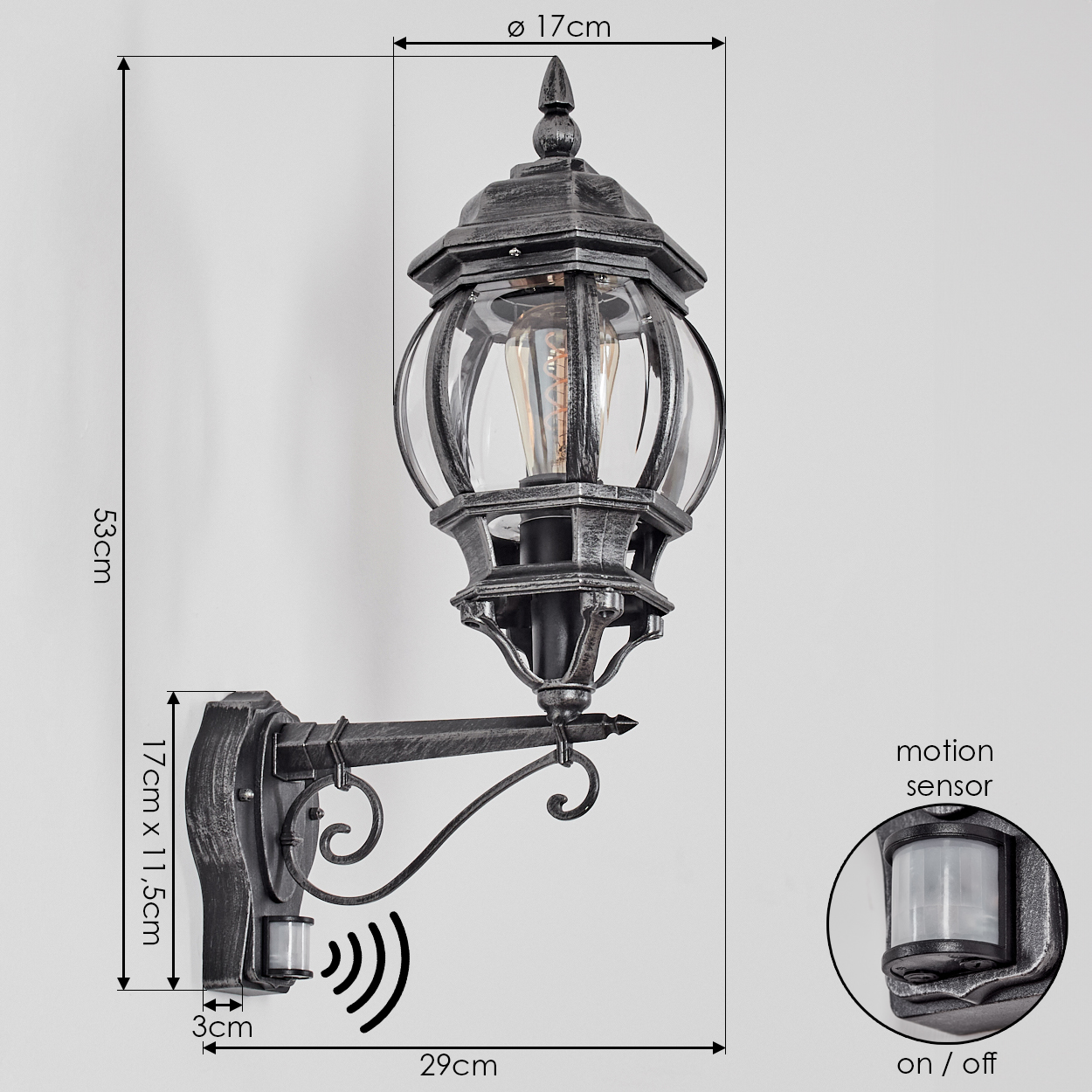 Außenwandlampe mit Bewegungsmelder. Schwarz-metallic-Finish, Glasplatten, Abmessungen beschriftet. Ein/Aus-Schalter sichtbar.