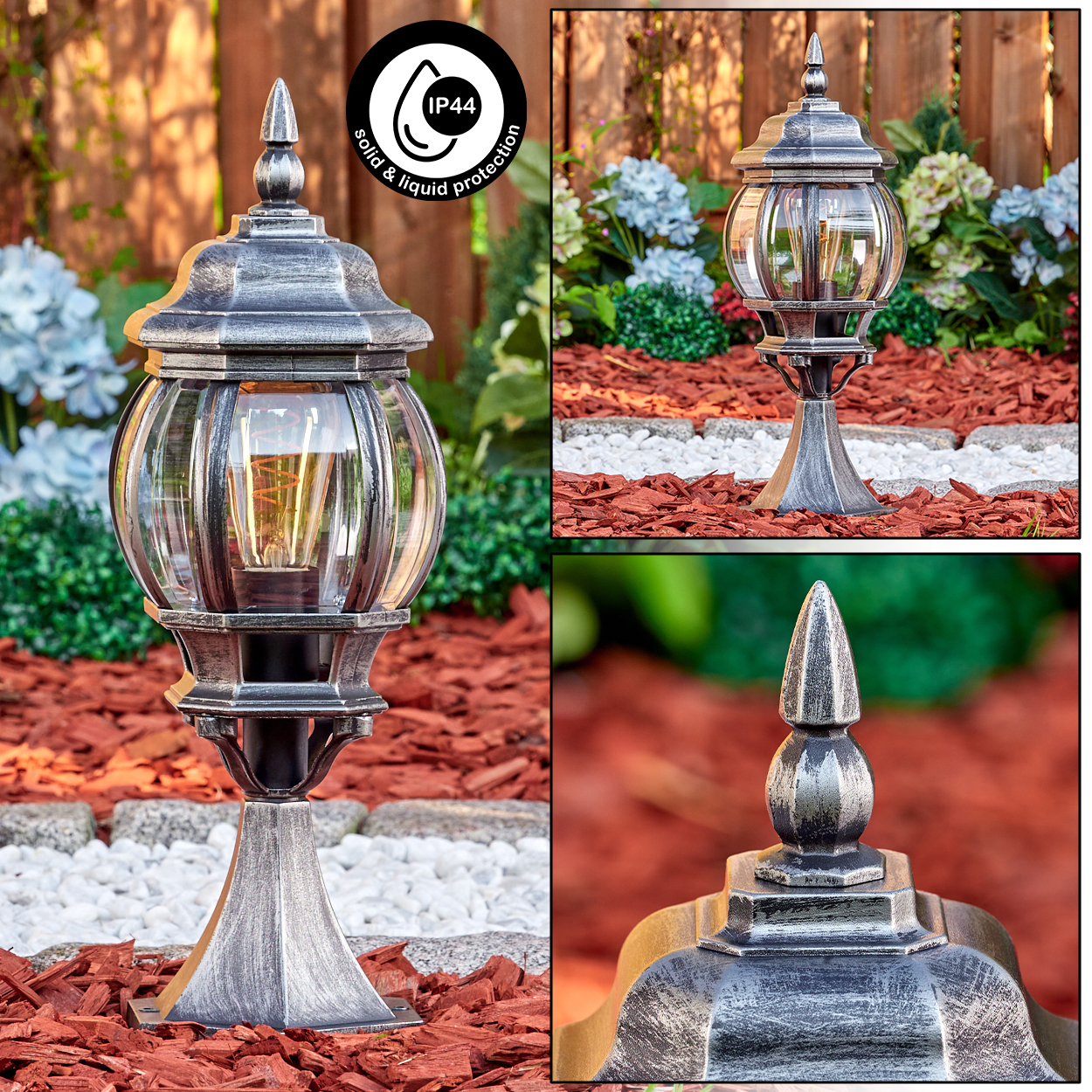 Dekorative Außenlampe, silber und schwarz, mit Glaskugel. Auf roter Mulch, mit weißem Steingrenze und grünen Pflanzen.