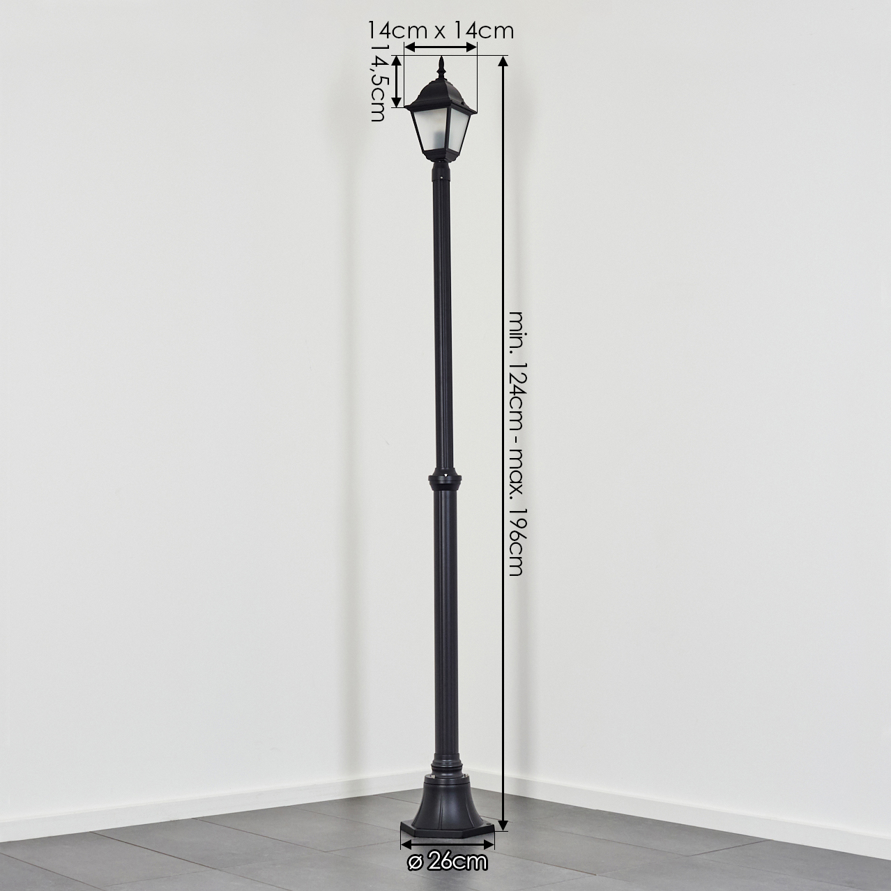 Eine schwarze Straßenlaterne steht in einer Ecke vor einer weißen Wand. Abmessungen und Maße sind auf dem Bild angegeben.