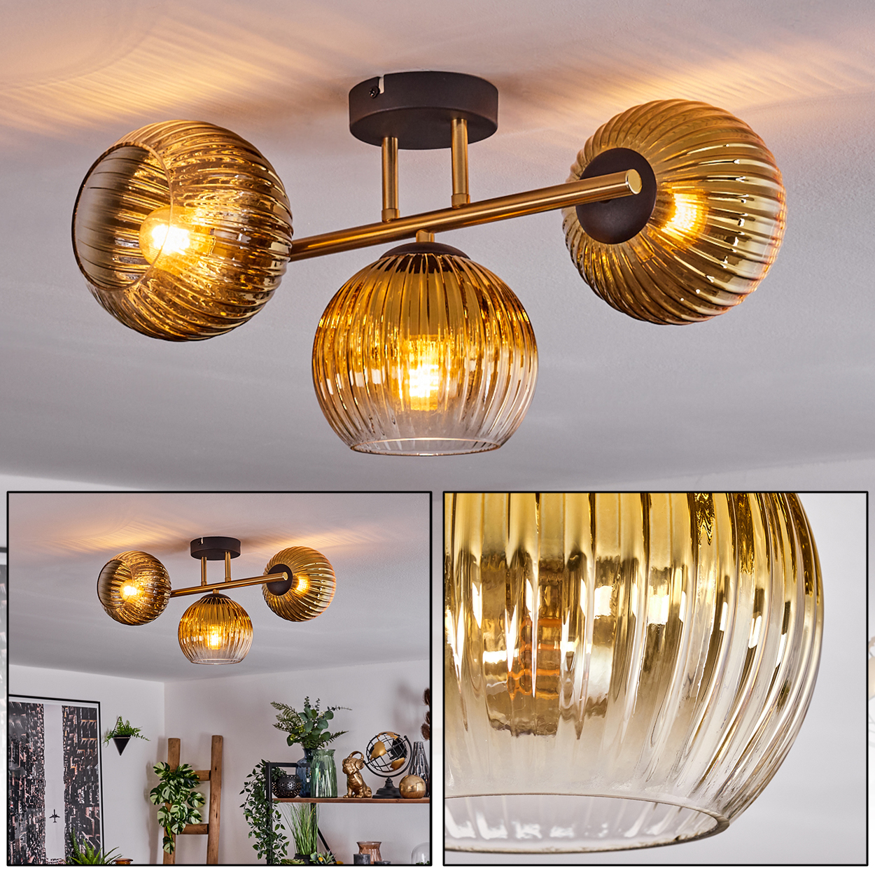 Eine moderne Deckenleuchte mit drei bernsteinfarbenen Glaskugeln, die warmes Licht ausstrahlen. Die Leuchte hat einen schwarzen Sockel und goldene Arme.