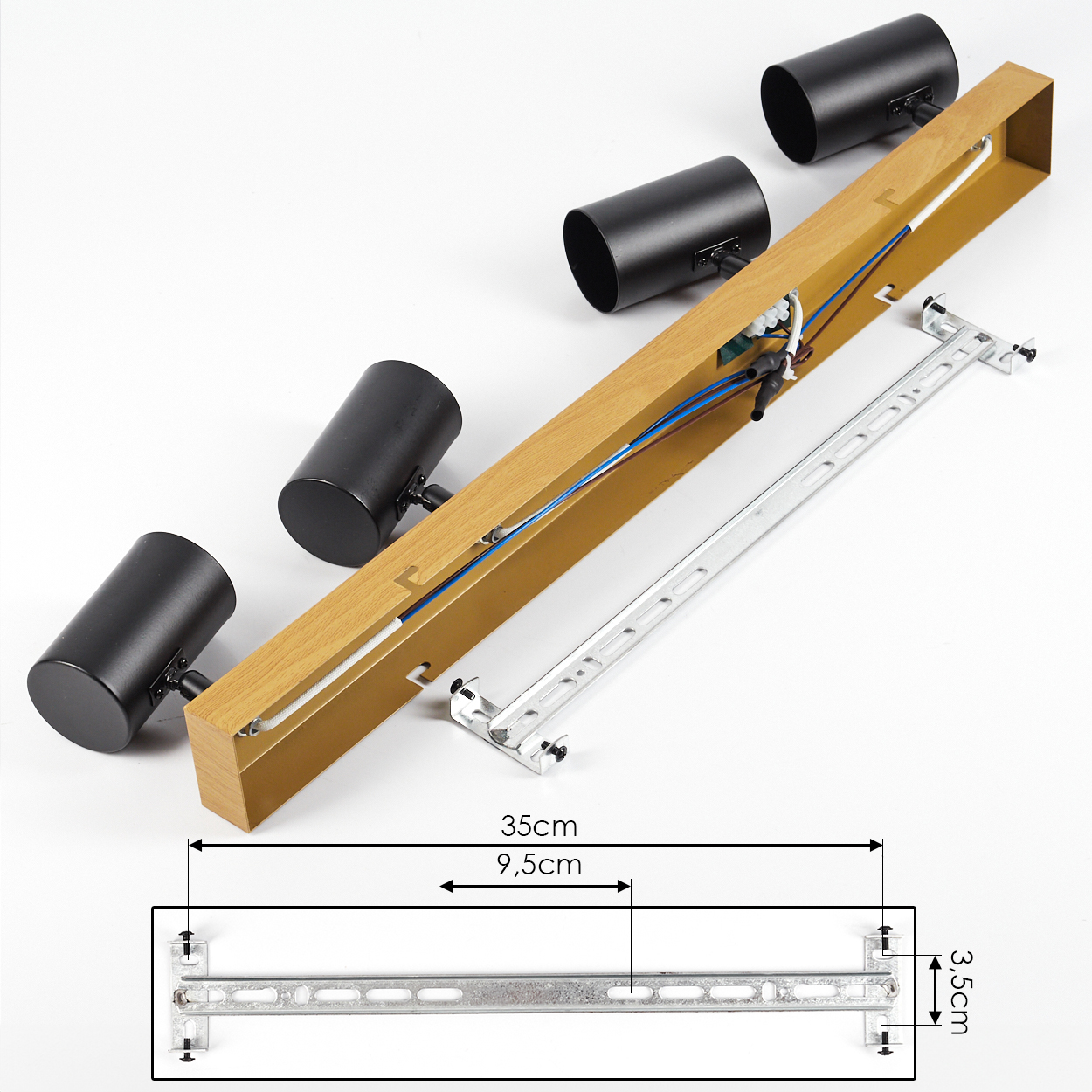 Zerlegte schwarz- und holzfarbene Strahler-Vorrichtung. Teile umfassen Strahler, Holzrahmen, Verkabelung und Metallhalterung. Maße sind angegeben.
