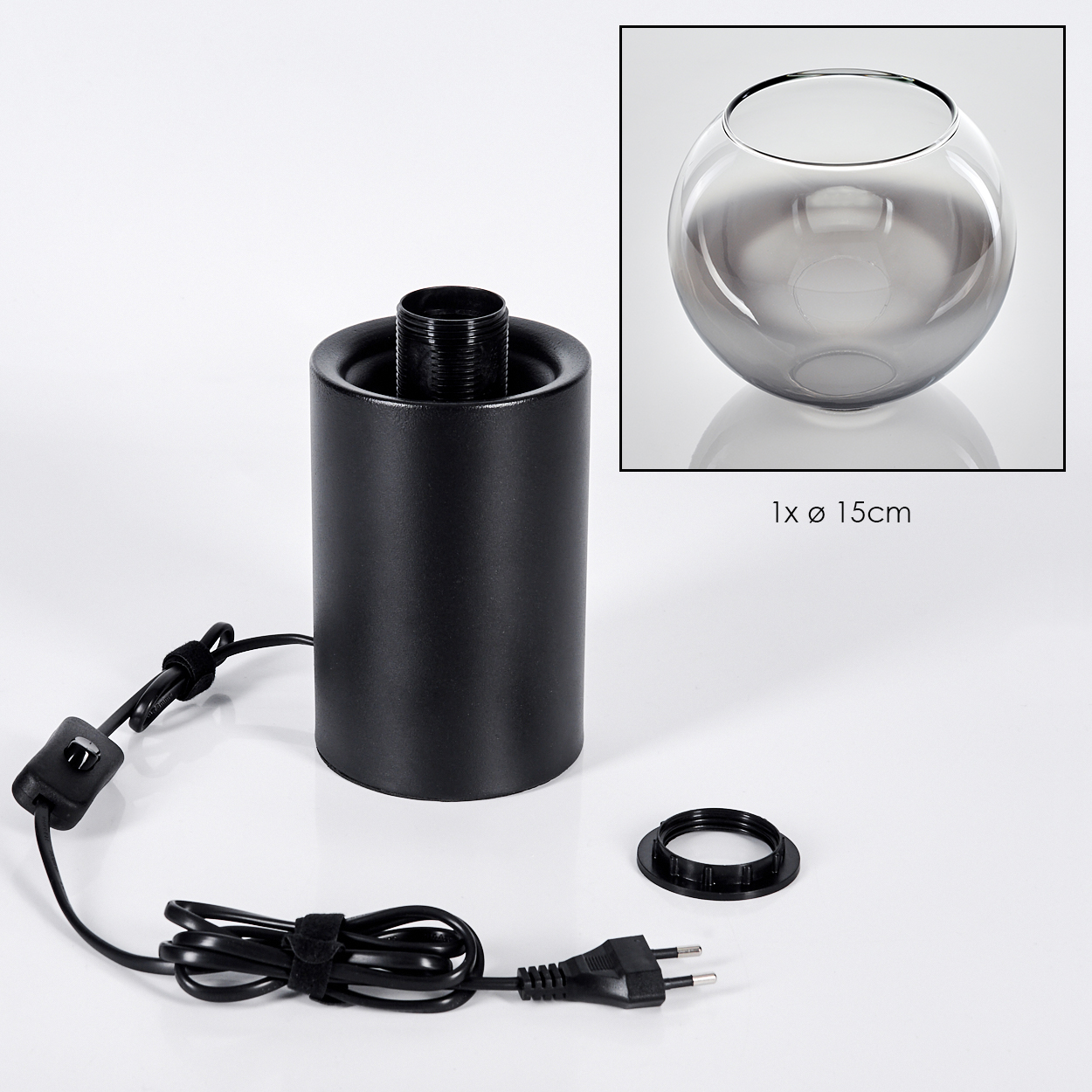 Eine schwarze Lampenbasis mit Netzkabel, Stecker und einem abgenommenen Ring. Eine graue Glasschale ist oben rechts.