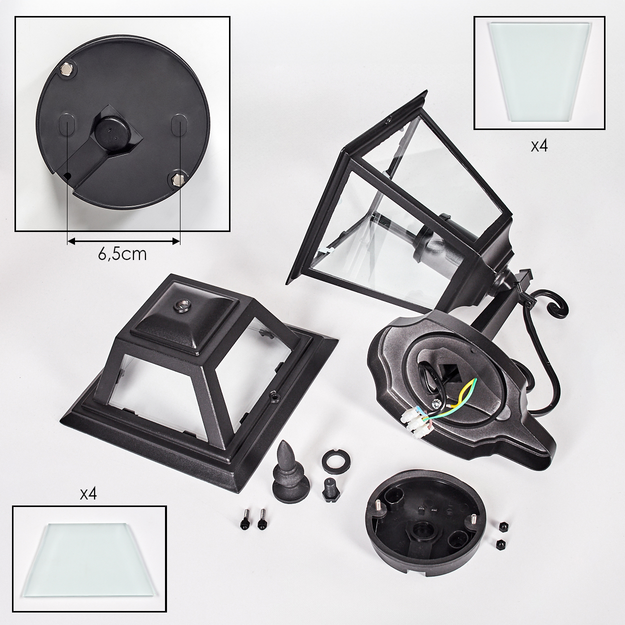 Zerlegte schwarze Außenlampenteile auf weißem Hintergrund. Enthält Glasscheiben, Sockel, Rahmen und kleine Hardware.