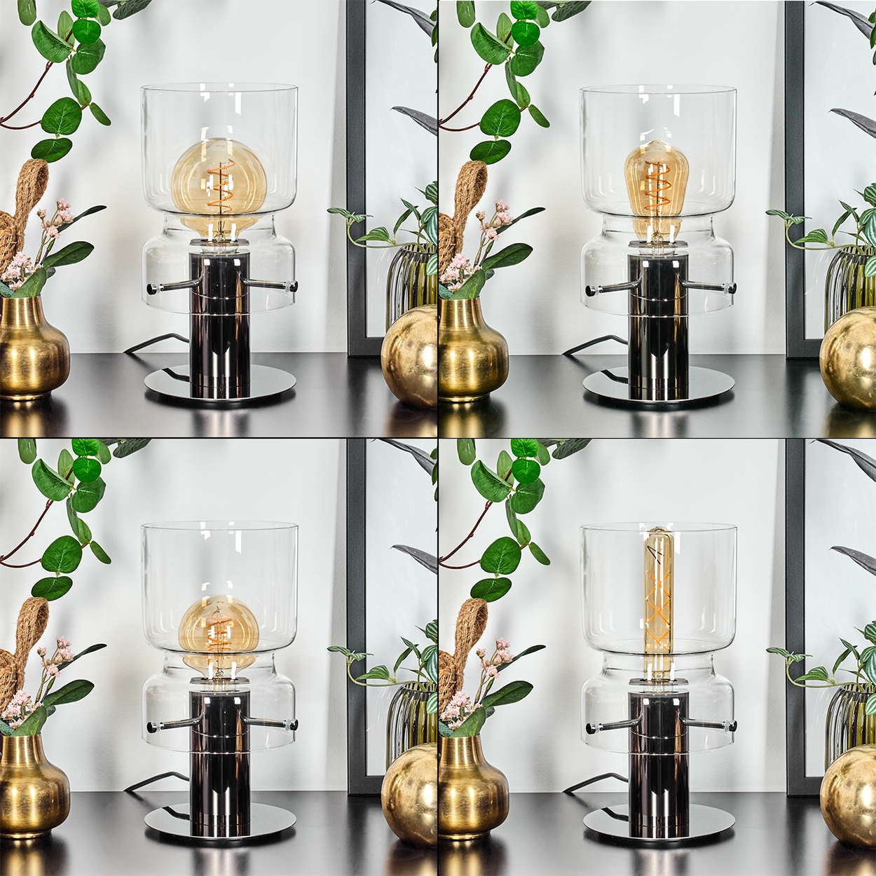 Eine moderne Lampe mit sichtbarer Glühbirne steht auf einer schwarzen Oberfläche. Daneben Vasen mit Blumen, grüne Blätter und ein gerahmtes Bild.