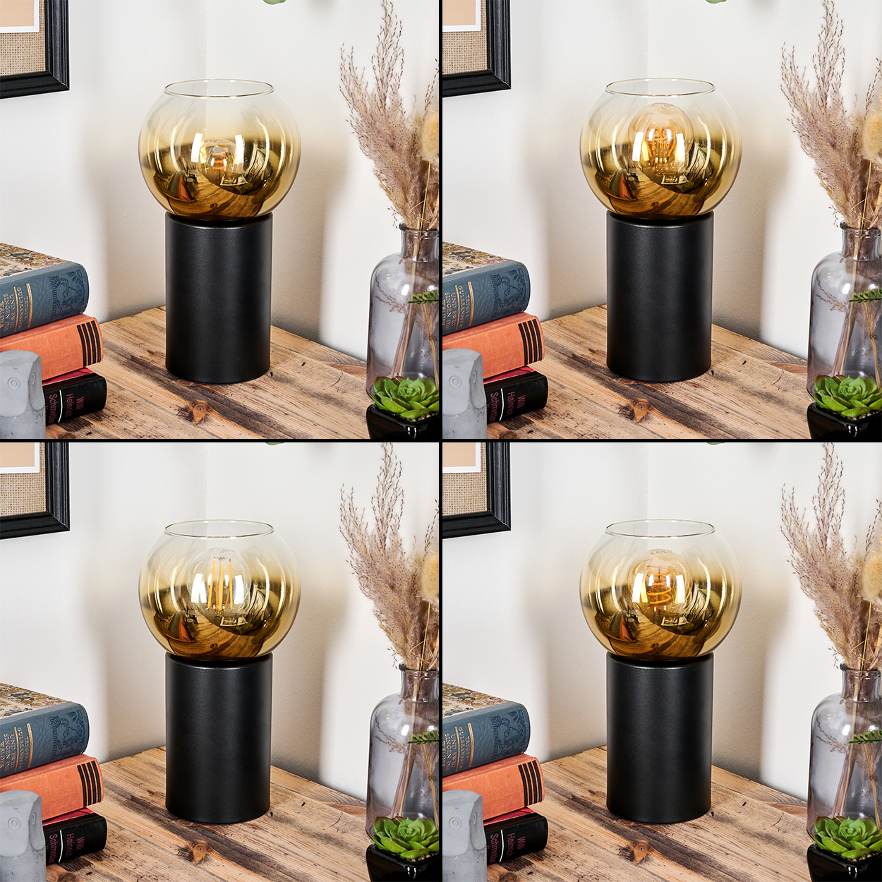 Eine Lampe mit goldenem Glasschirm steht auf einem schwarzen Sockel. Bücher, Vasen mit Pflanzen und eine kleine Stein-Eule sind ebenfalls auf dem Tisch.