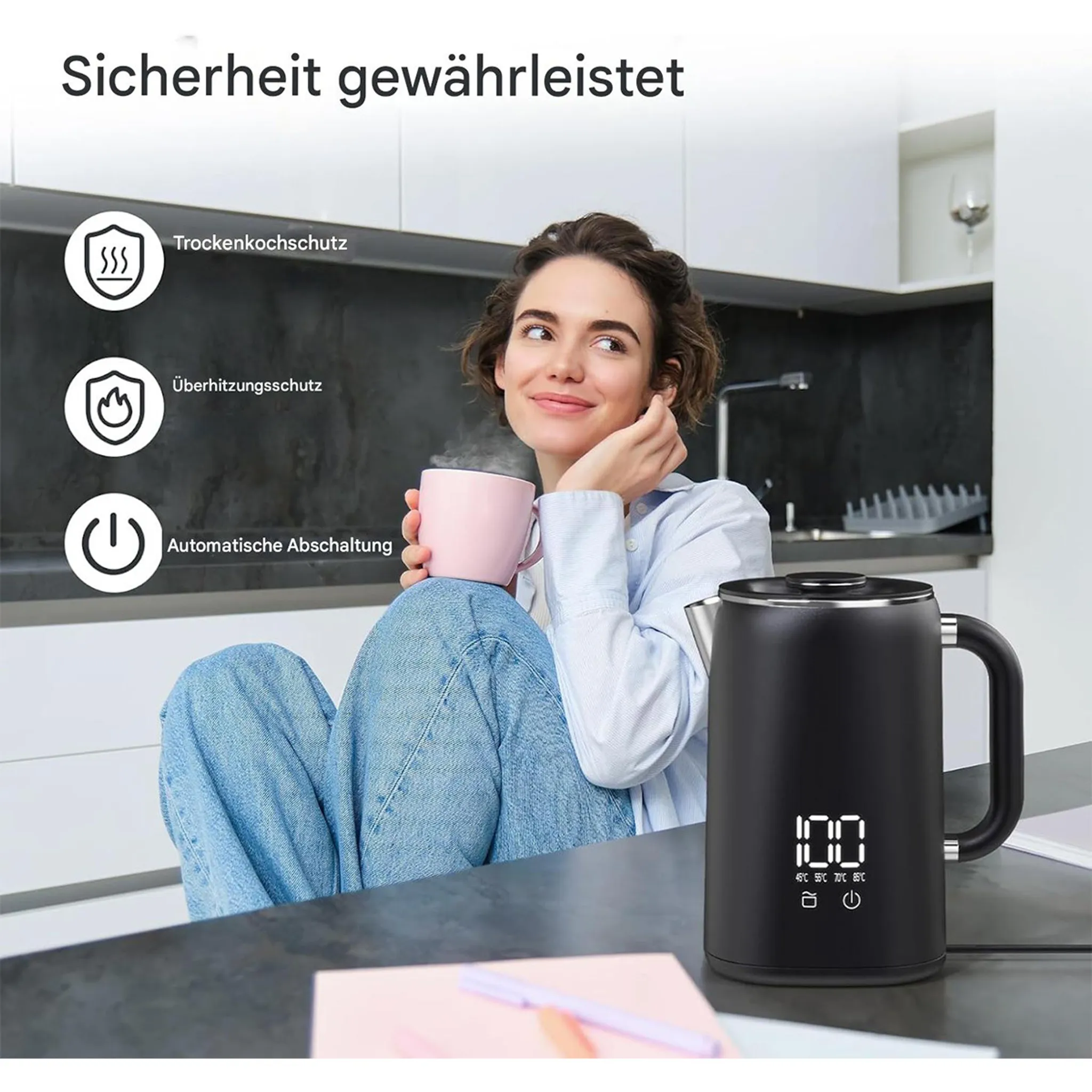 Eine Frau sitzt mit einer rosa Tasse, Dampf steigt auf. Ein schwarzer Wasserkocher mit Digitalanzeige steht neben ihr.