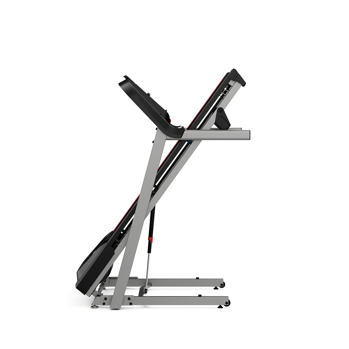 A treadmill, folded, side view. The frame is silver, the running surface is black and red. It is on a white background.