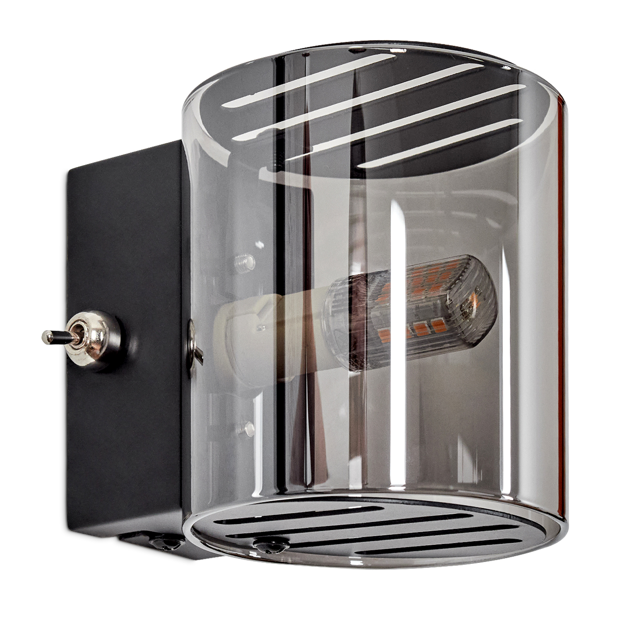 Eine moderne Wandleuchte mit schwarzem Sockel, silbernem Schalter und einem zylindrischen Glasschirm, der ein orangefarbenes LED-Licht umschließt.