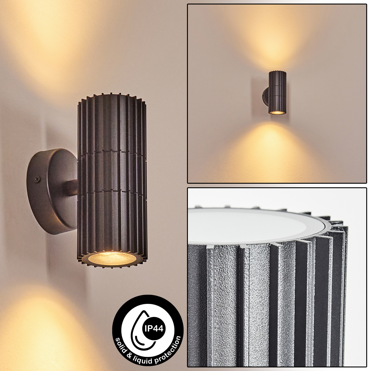 Dunkelgraue, zylindrische Außenwandleuchte. Die Lampe hat einen geriffelten Körper und gibt warmes Licht ab. IP44-Symbol sichtbar.