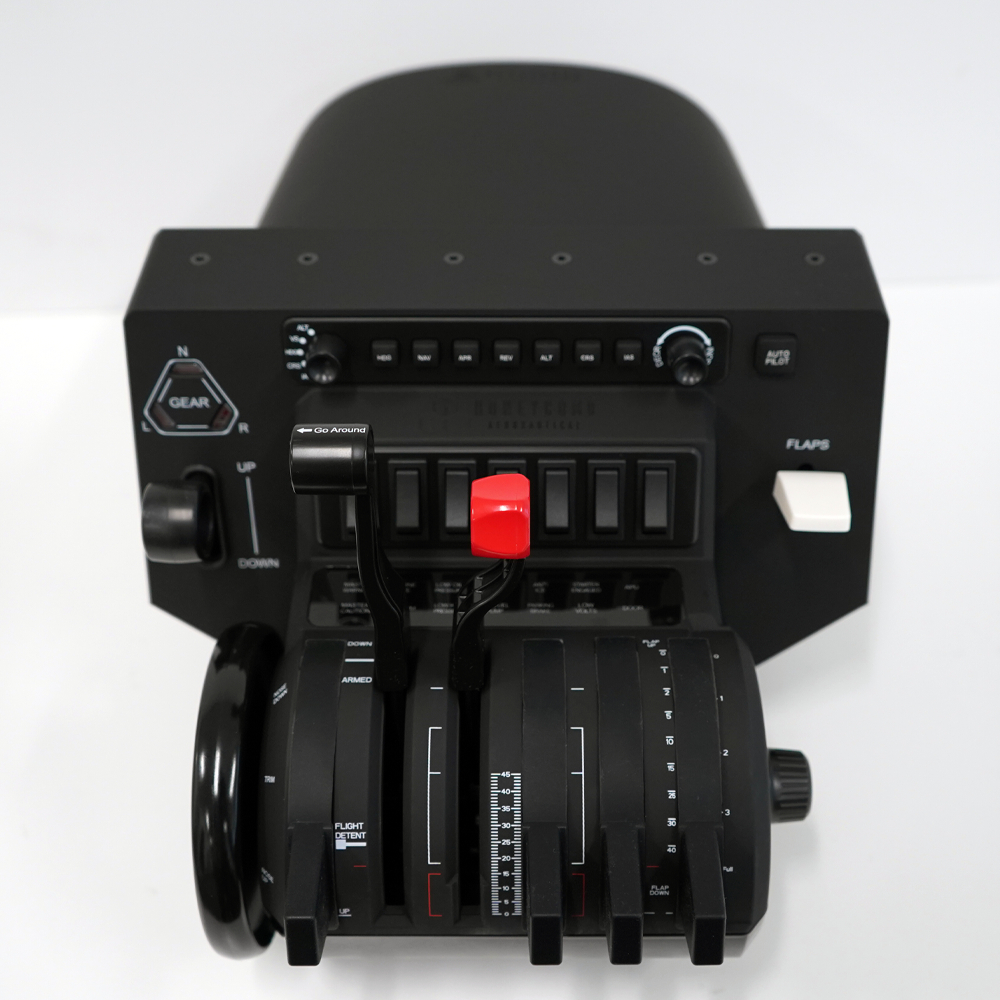 A black flight control panel with levers, buttons, and switches. A red handle is prominent. The background is white.