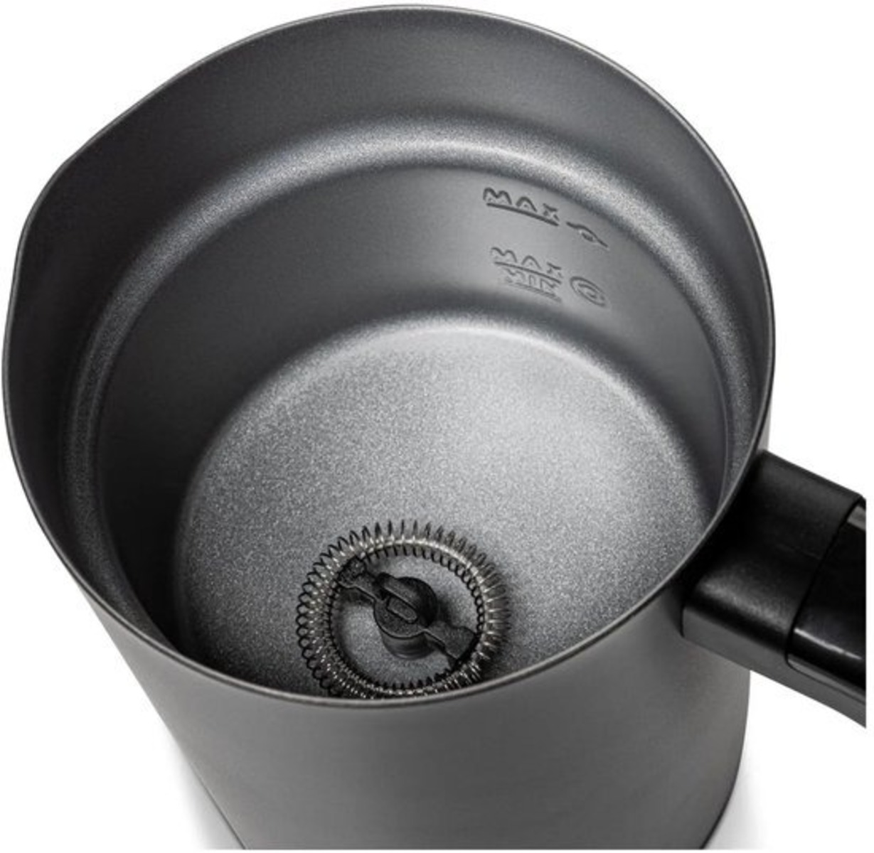 A dark gray milk frother. Inside the frother is a whisk. There are 'MAX' and 'MIN' markings. A black handle is on the side.