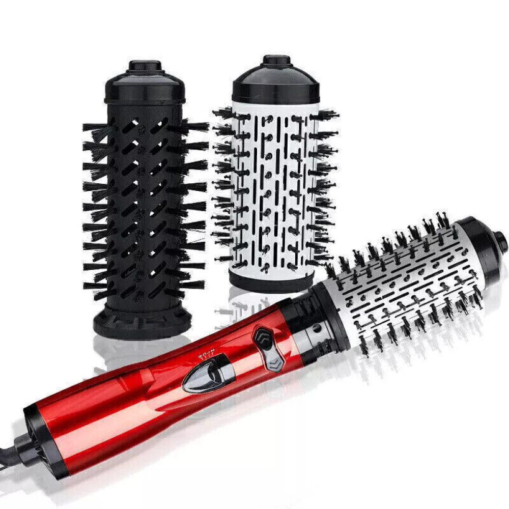Ein rotes und schwarzes Haarstyling-Werkzeug mit drei austauschbaren Bürstenköpfen. Zwei sind zylindrisch, einer schwarz, einer weiß. Der Griff ist rot.