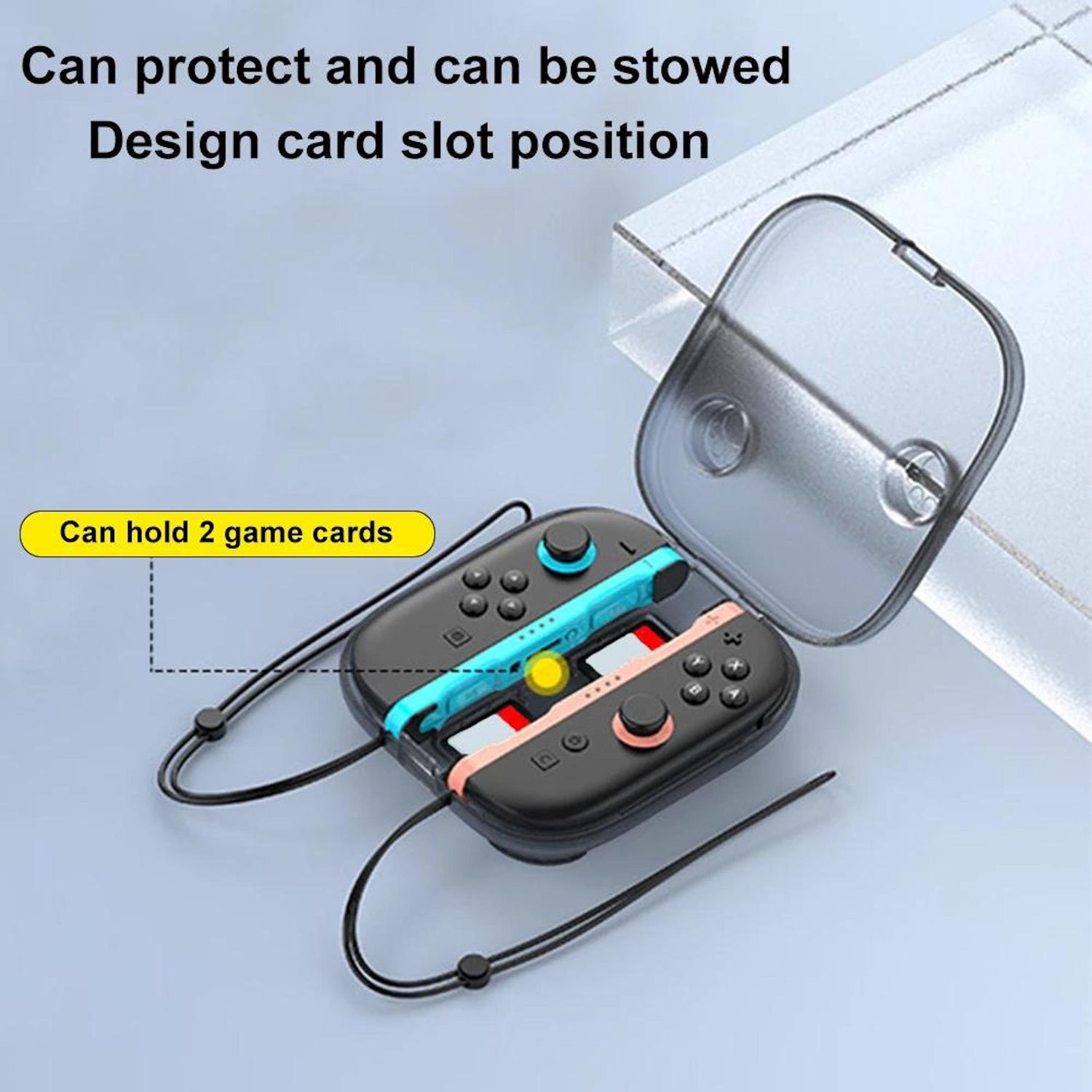 Un controlador de juegos negro con detalles en azul y rosa, dos tarjetas de juego y una funda protectora transparente.