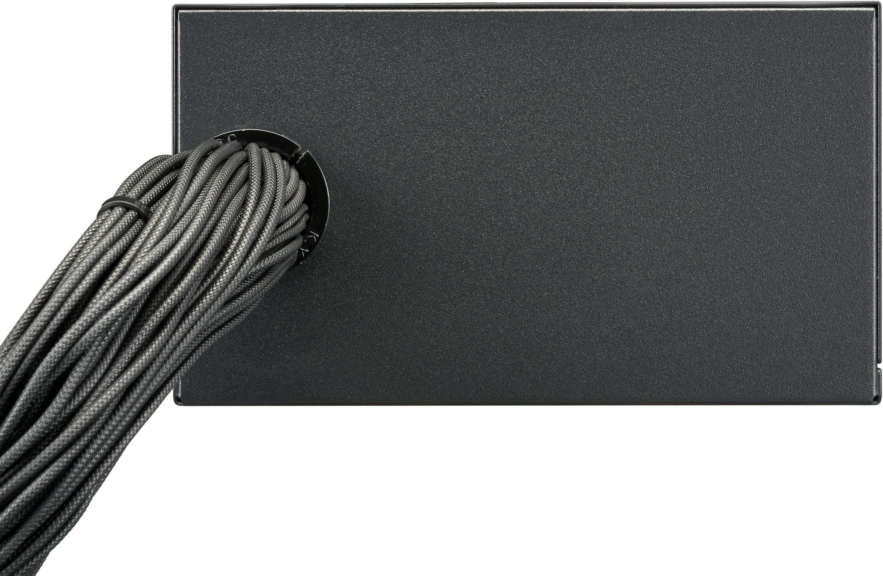 Close-up of a black computer component with a bundle of gray braided cables.