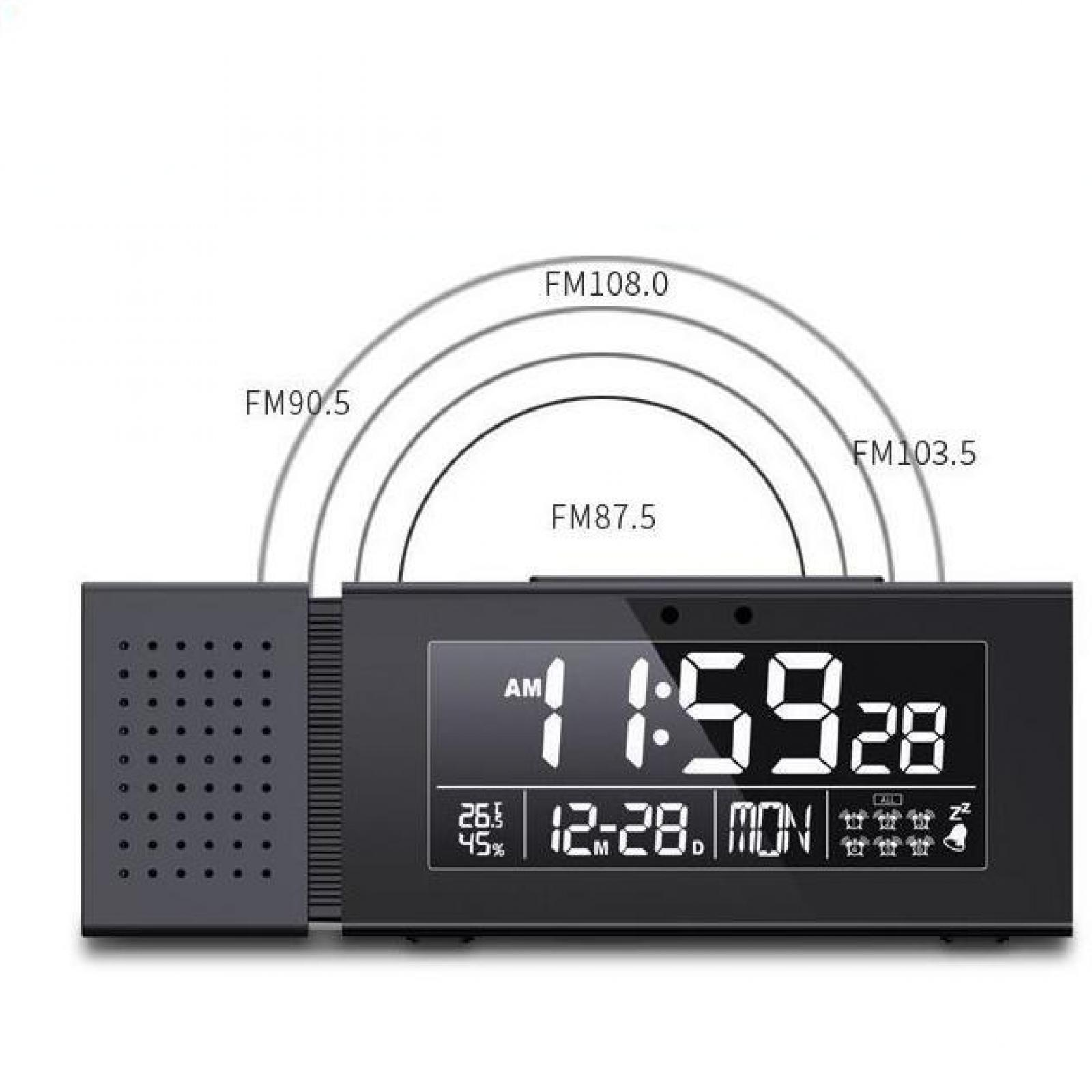 Schwarze Digitaluhr mit der Anzeige 11:59:28 und Radiofrequenzen darüber. Inklusive Temperatur, Datum und Wochentag.
