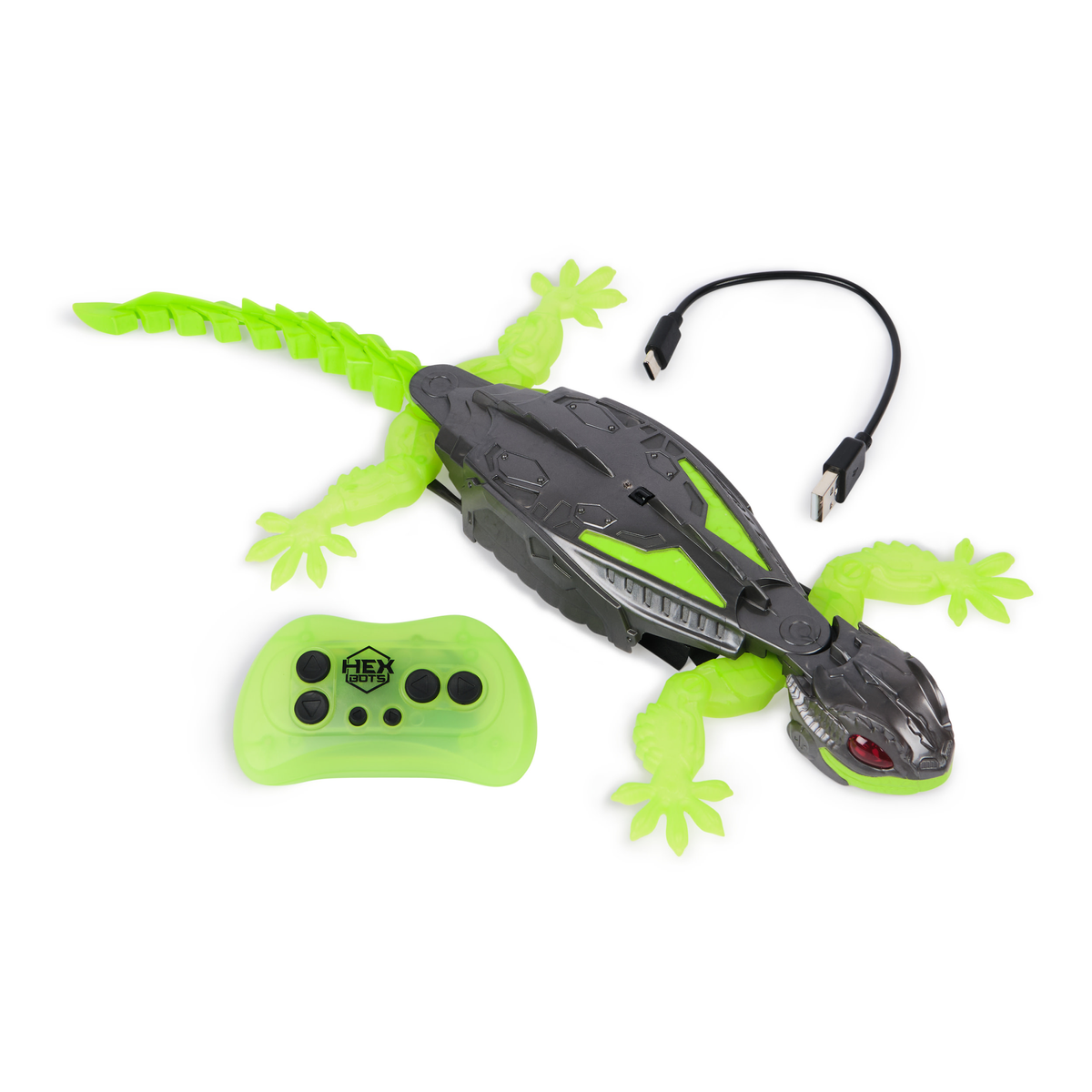 Un lagarto de juguete con mando a distancia y cable USB. El lagarto es verde y gris. El mando a distancia también es verde.