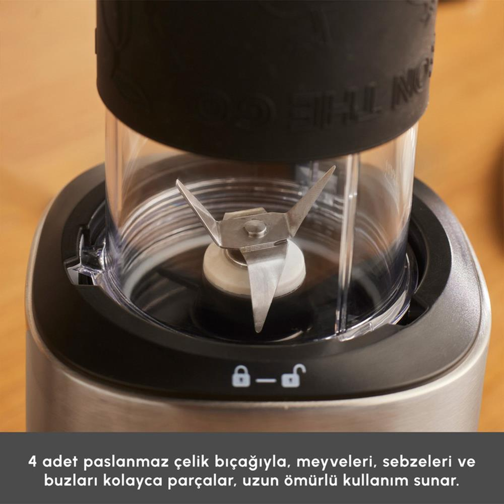 Blenderin yakın çekimi. Şeffaf bir kap içinde paslanmaz çelik bıçaklar, siyah kapak. Kilit sembolü olan metal taban.