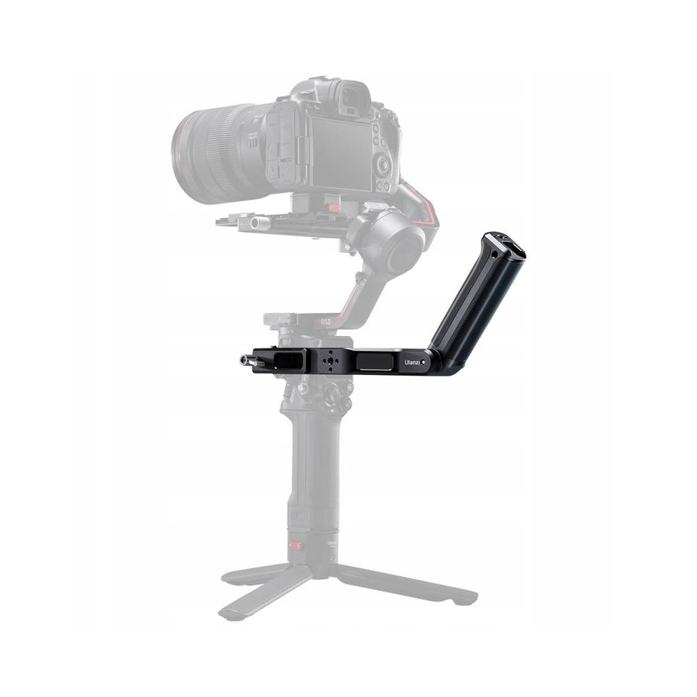 Stabilizator kamery z zamontowaną kamerą. Stabilizator jest czarny. Aparat jest nieostry.