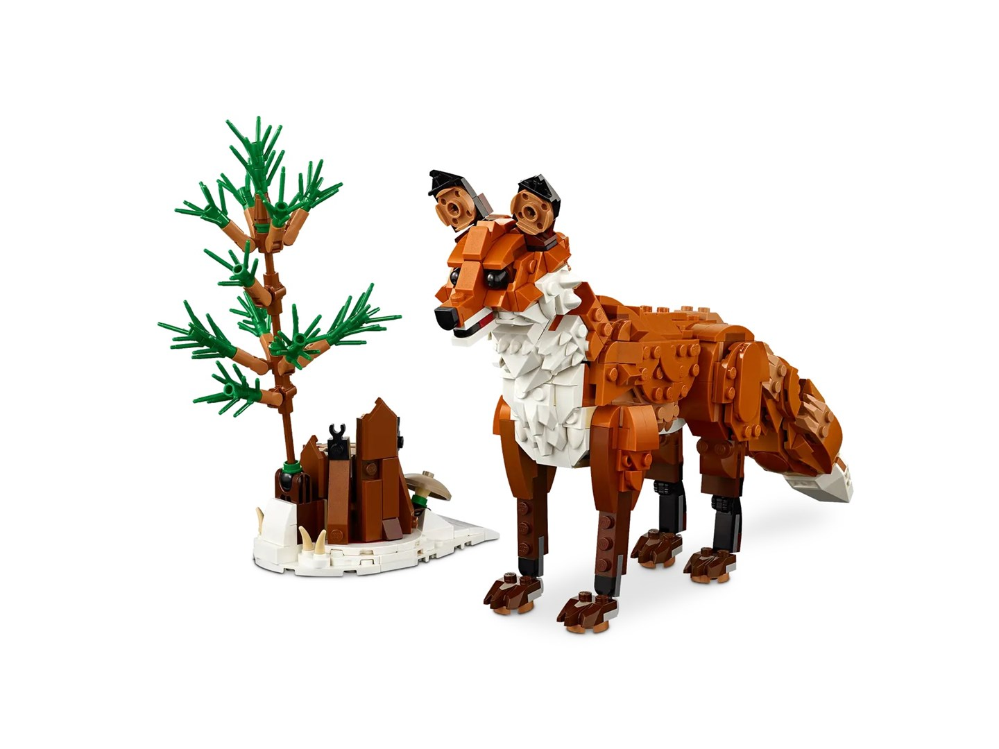 Una volpe Lego e un alberello fatto di mattoncini Lego sono su una superficie bianca. La volpe è marrone, bianca e nera.