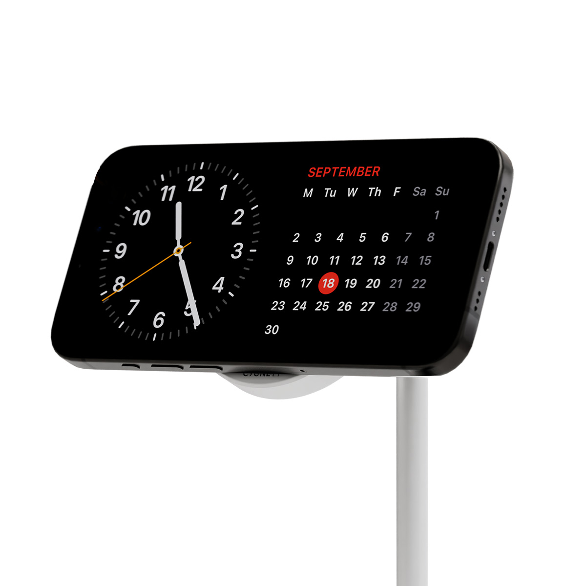 Ein Telefon zeigt eine Uhr und einen Kalender für September. Das Datum ist hervorgehoben. Das Telefon ist weiß und schwarz. Es steht auf einem weißen Ständer.