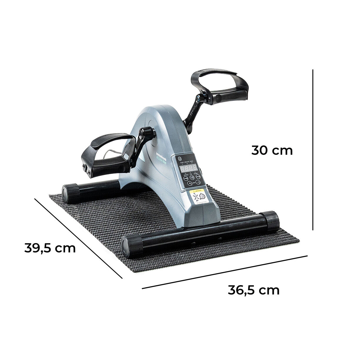 Una bicicleta de ejercicios gris con pedales y pantalla descansa sobre una esterilla negra. Dimensiones: 39,5 cm, 36,5 cm y 30 cm.