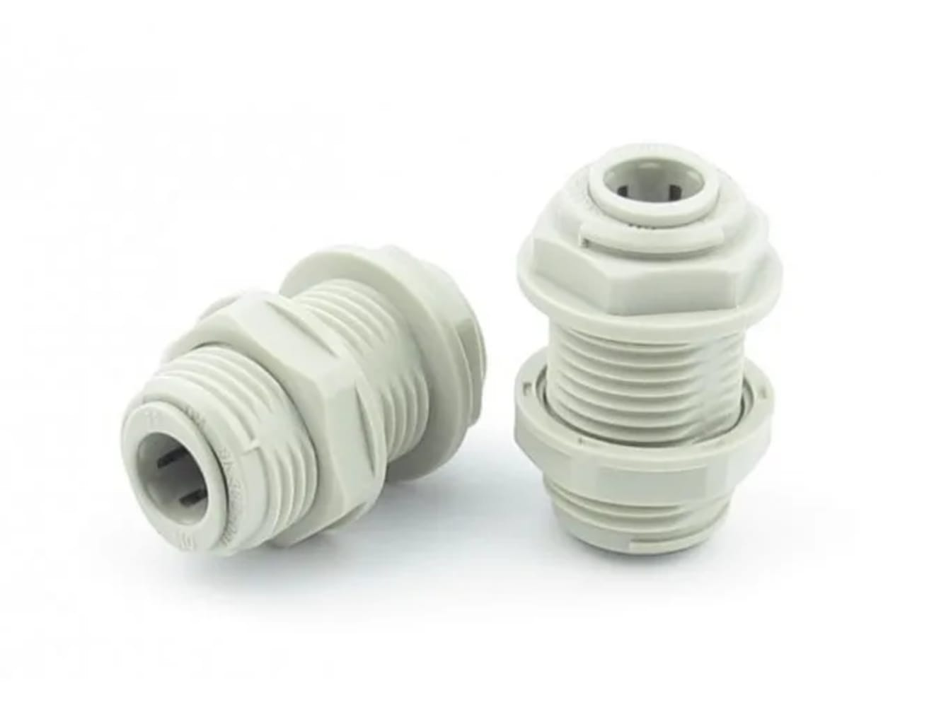 Two gray plastic cable glands on a white background. One lies on its side, the other stands upright.