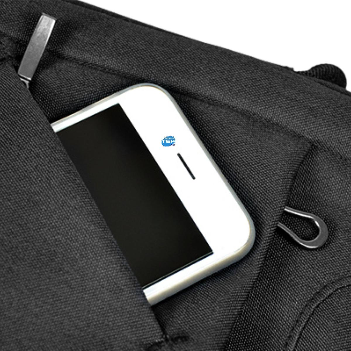 Uno smartphone bianco con schermo nero è parzialmente in una tasca nera. Hardware in metallo visibile. Inquadratura ravvicinata.