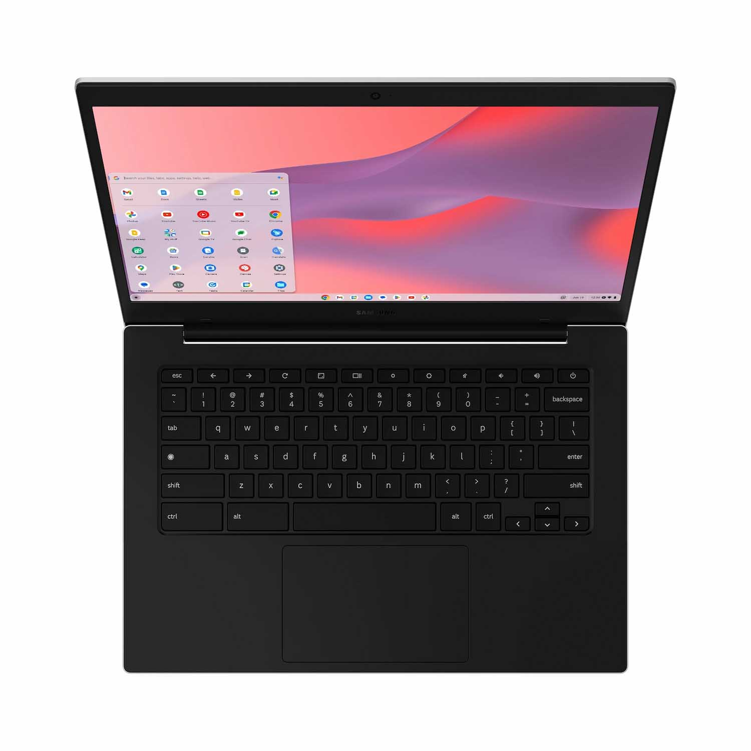 Una laptop negra está abierta. La pantalla muestra un escritorio con iconos de aplicaciones. El teclado y el panel táctil son visibles. El fondo es blanco.