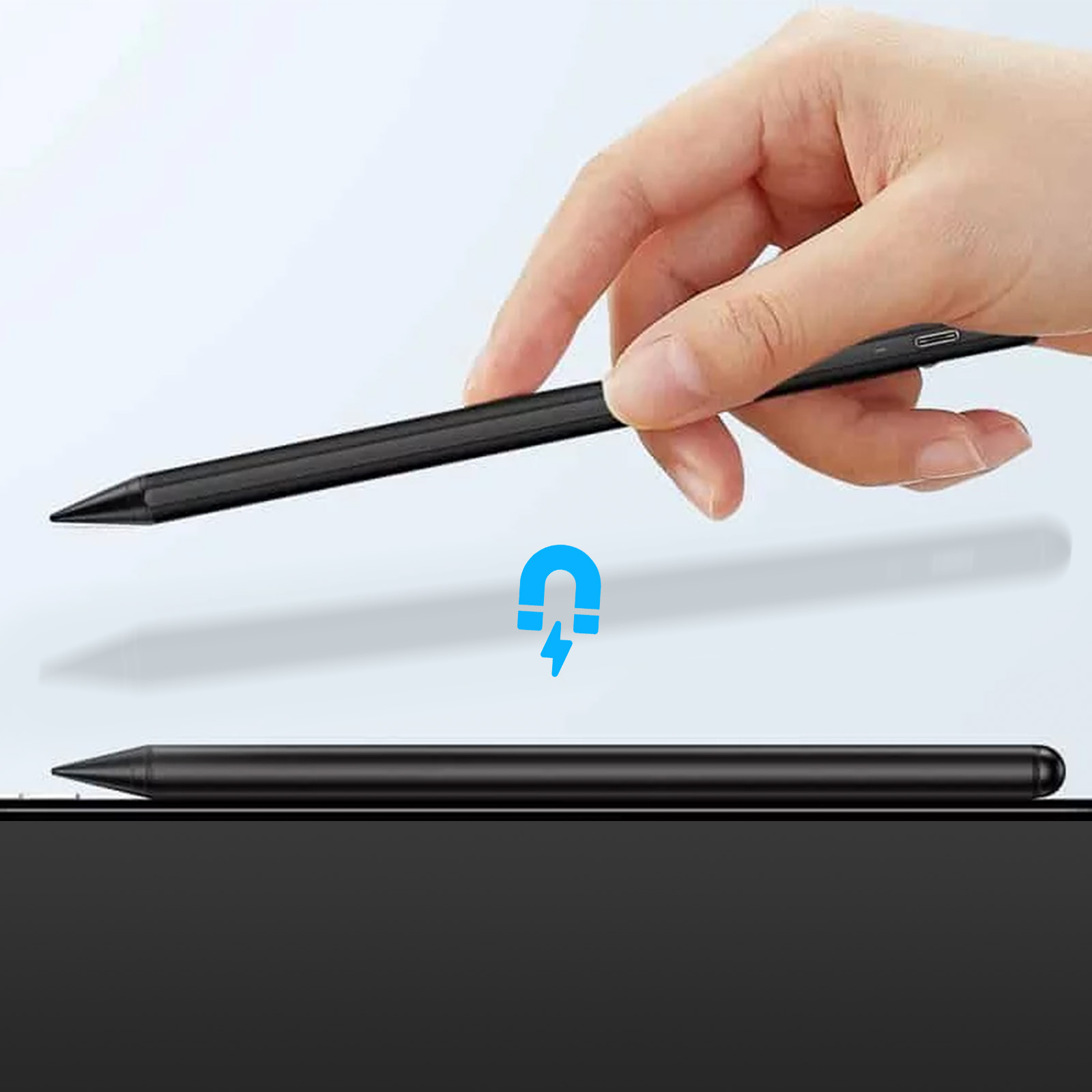 Eine Hand hält einen schwarzen Stift über einem anderen auf einer schwarzen Oberfläche. Ein blaues Magnetsymbol schwebt dazwischen.