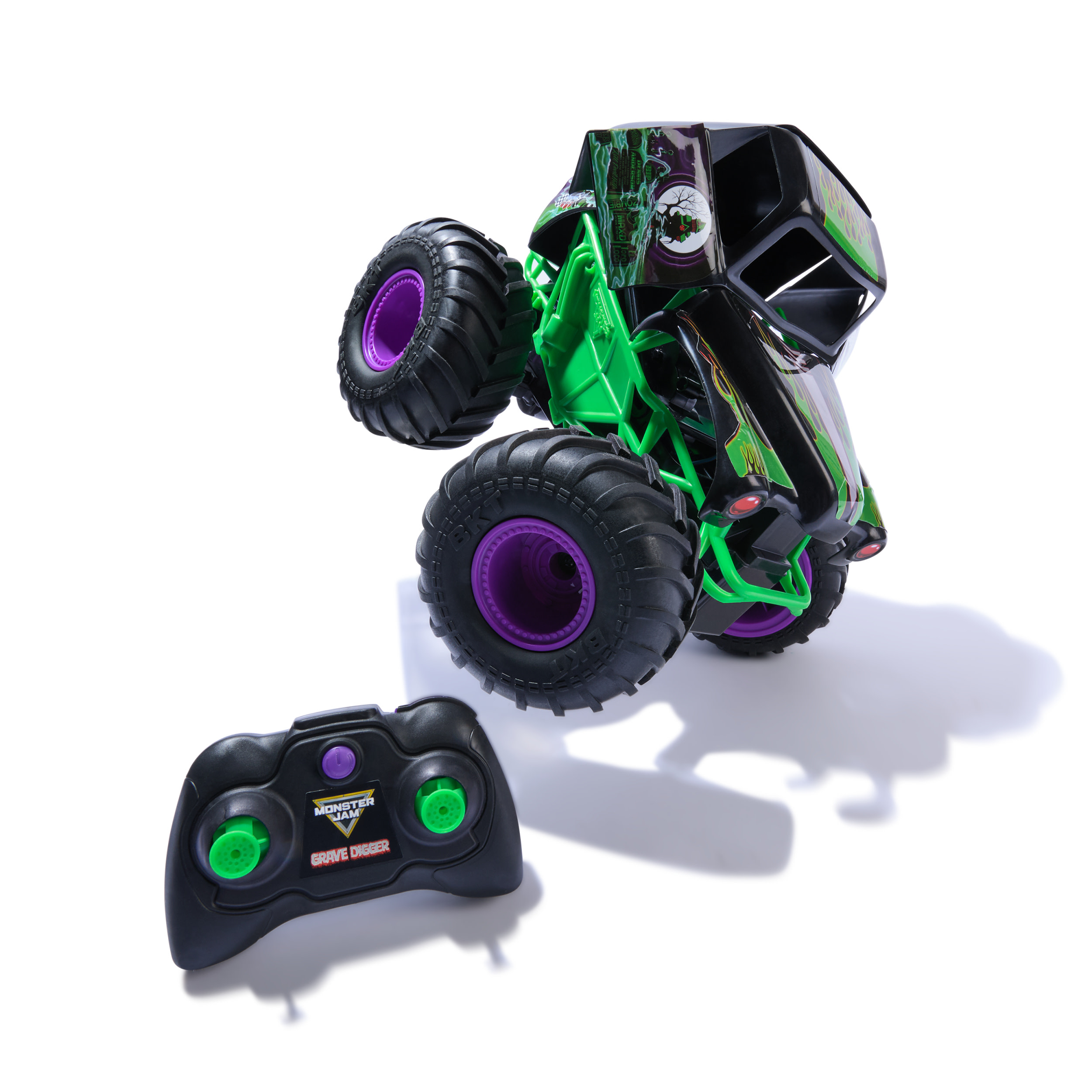 Zabawkowy Monster Jam Grave Digger z pilotem, czarny, zielony i fioletowy na białym tle.