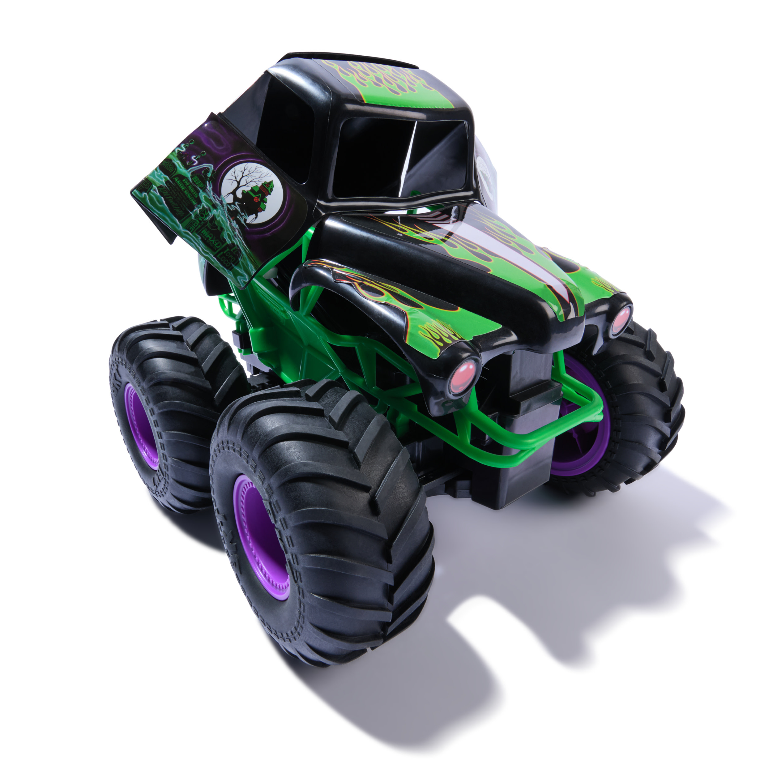 Zabawkowy monster truck z czarnym nadwoziem, zielonymi akcentami, fioletowymi kołami i dużymi oponami, rzucający cień.