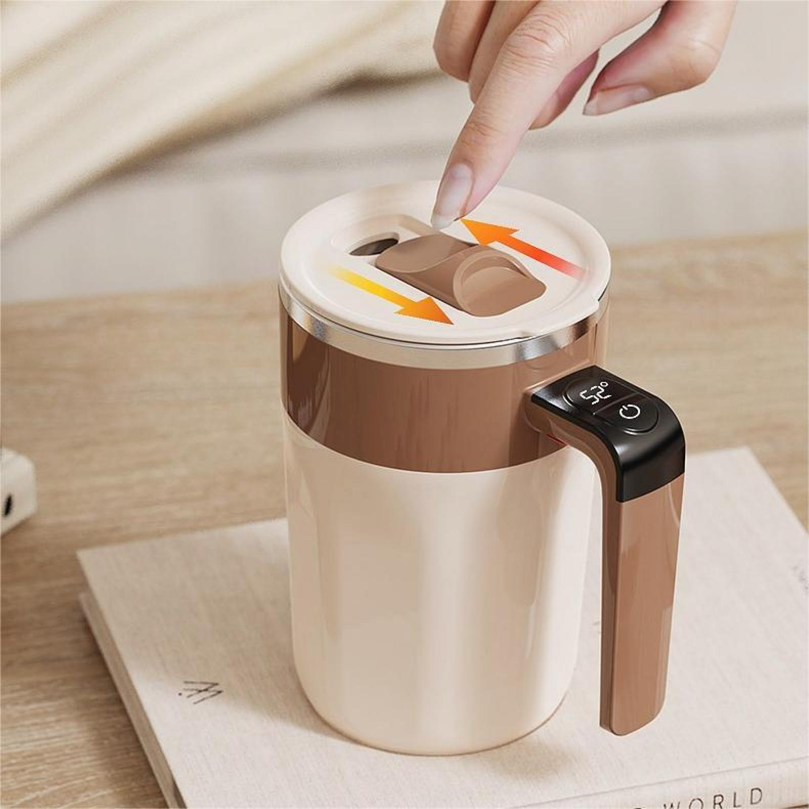 Eine Hand öffnet einen Kaffeetassendeckel mit Pfeilen. Die Tasse ist weiß und braun, mit Griff und Digitalanzeige.