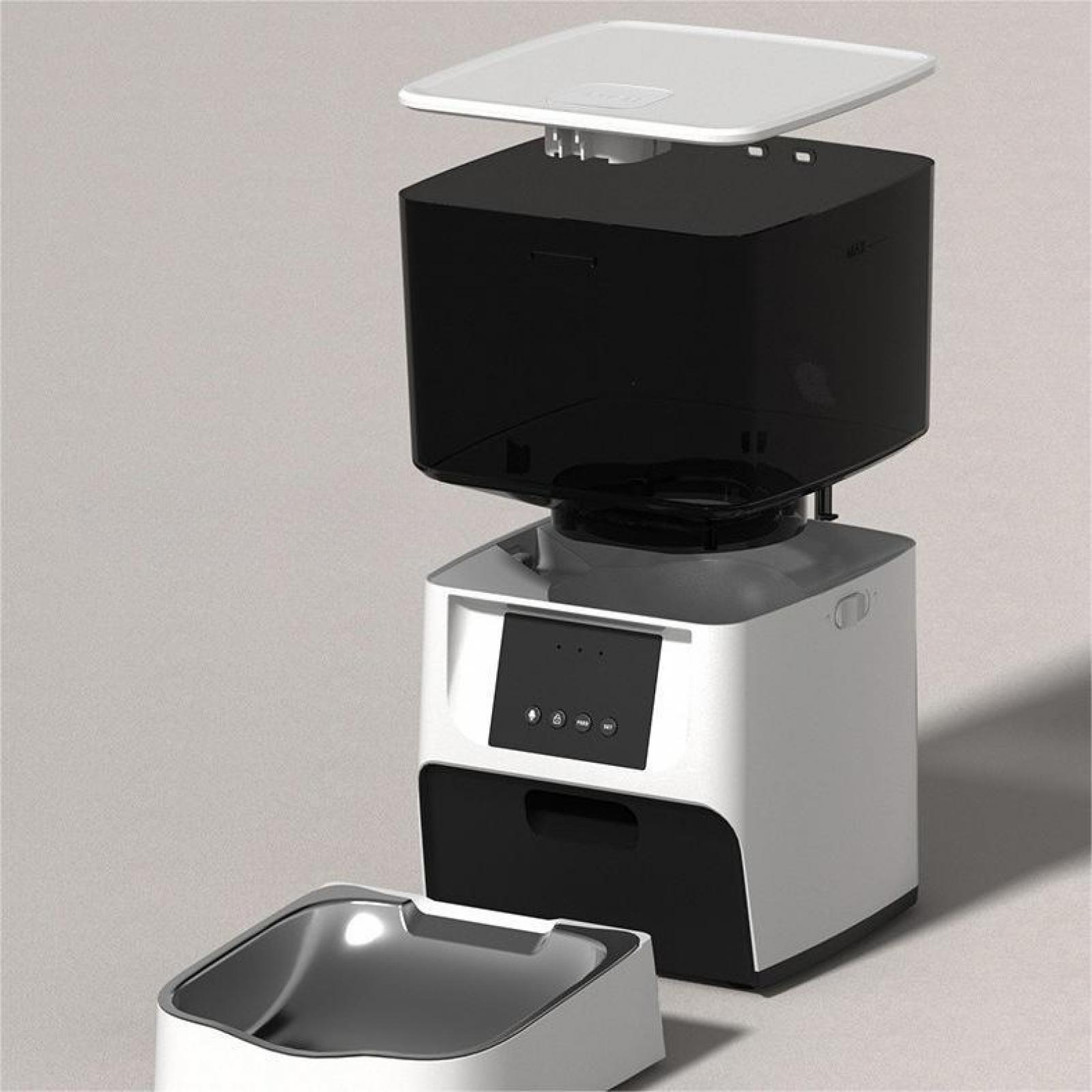 Ein weiß-schwarzer Futterautomat mit Futternapf. Oberteil und Behälter sind schwarz, Basis ist weiß. Schüssel ist Metall.