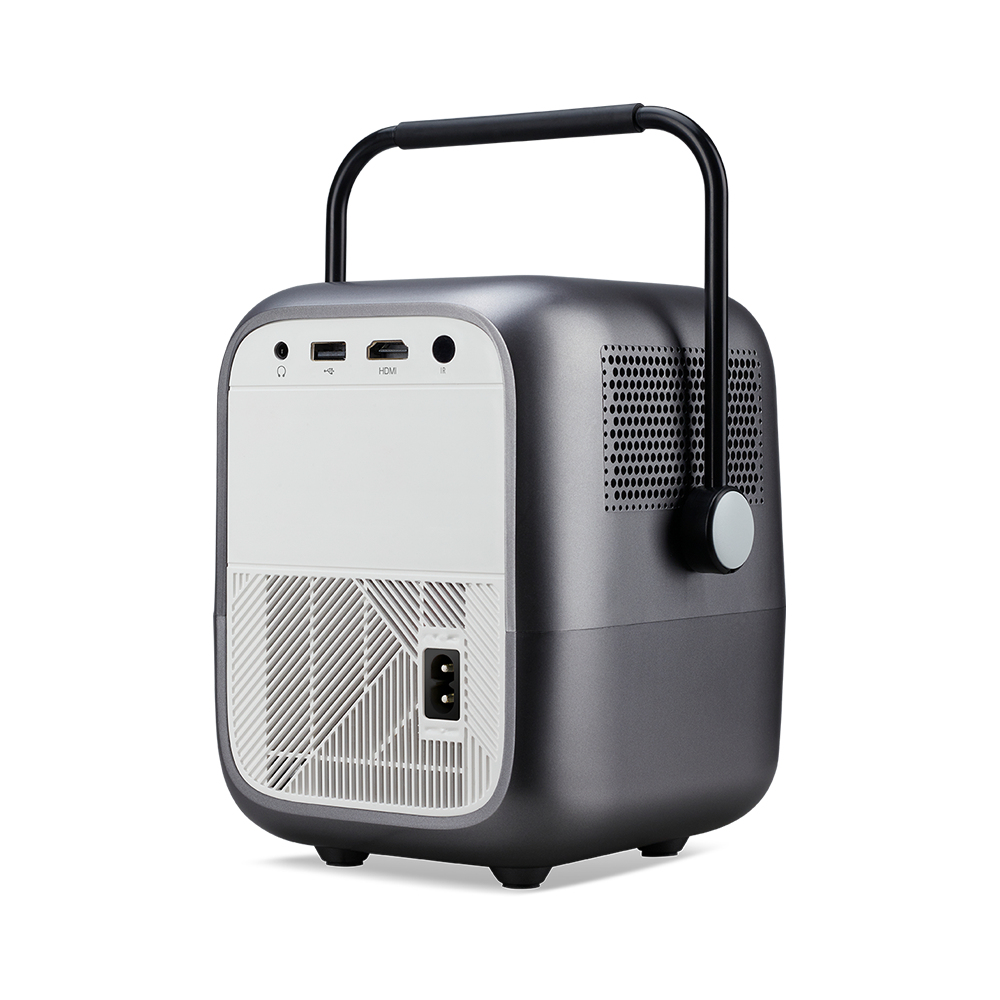 A gray portable projector with a black handle. It has a white back panel with ports and a power connector. The projector sits on a white background.