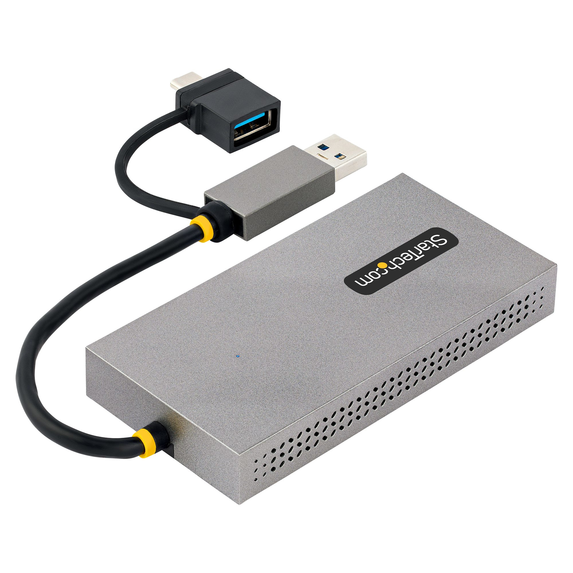 Un concentrador StarTech plateado con cables y conectores. Hay un cable USB-C y USB-A conectado. Está sobre un fondo blanco.