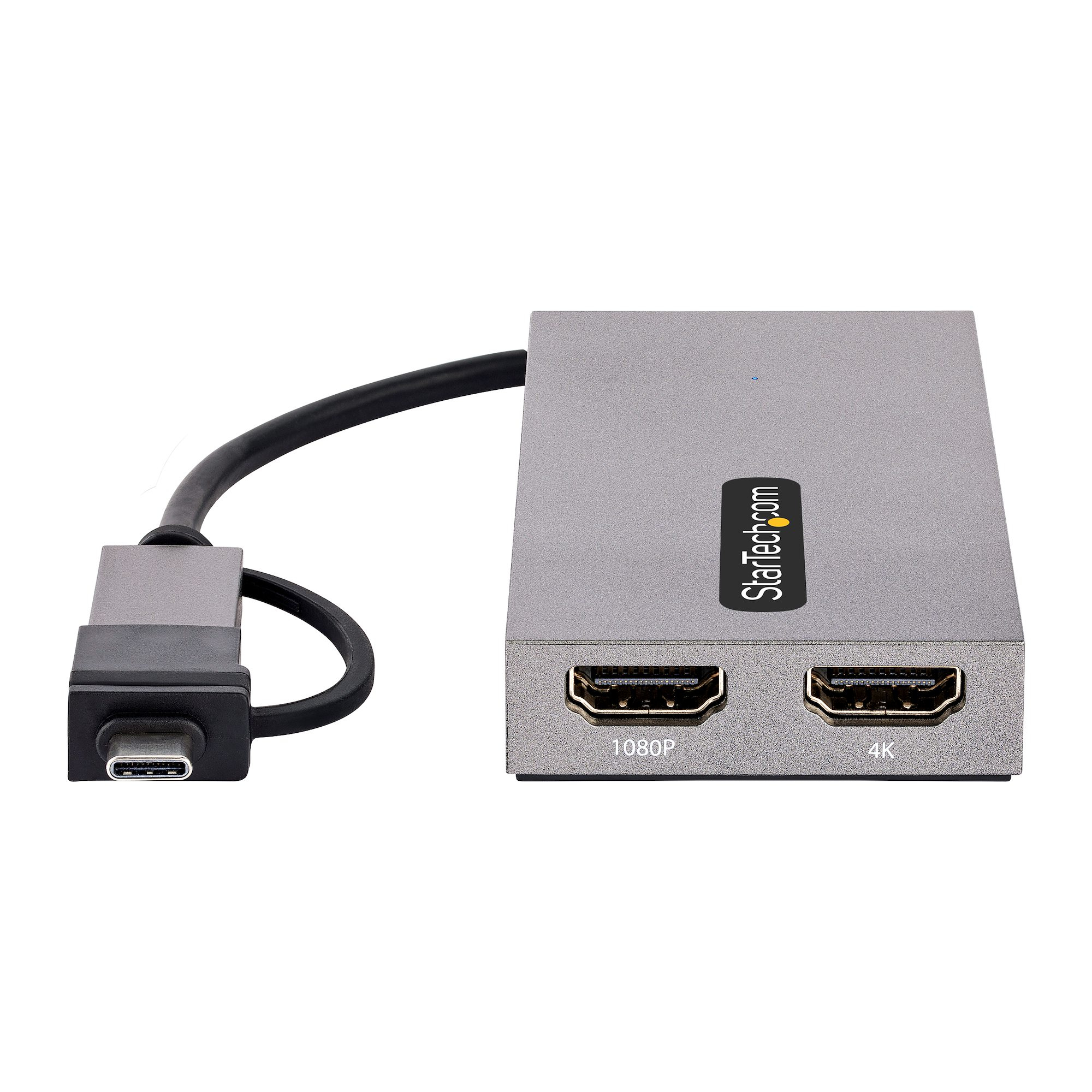 Un adaptador HDMI gris con cable negro. Tiene dos puertos HDMI etiquetados 1080P y 4K, y un conector USB-C.